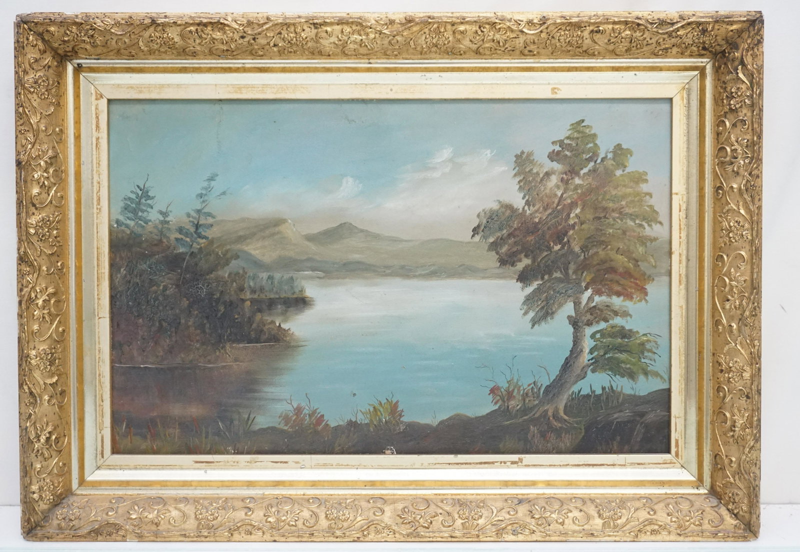 ADIRONDACK LAKE OIL ON BOARD: Antique Adirondack Lake Scene Oil on Board. Purchased in Lake Placid, NY. In gold leaf wood period frame. In frame 22 1/2"x16"x2". Weight 4 pds. PROVENANCE: The Estate of Edwin Joseph Hamblet, Portlan