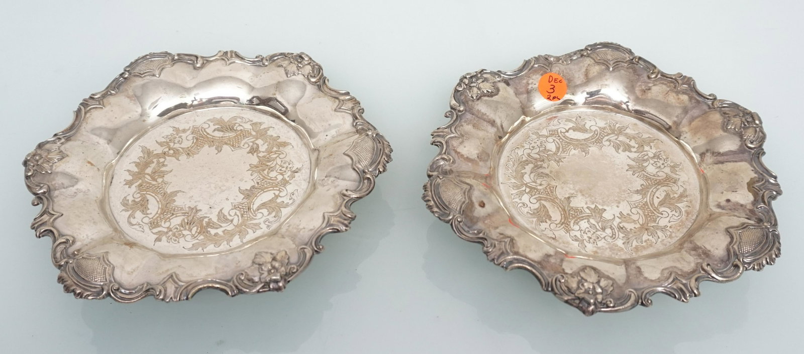 2 ANTIQUE SILVERPLATE WINE COASTERS: Matched Pair of Antique Silver on Copper Etched Wine Coasters. 8 1/4"x1 1/4". Weight combined 2 pds. PROVENANCE: The Estate of Mrs. John Rutherfoord Bennett of Charleston, by descent.