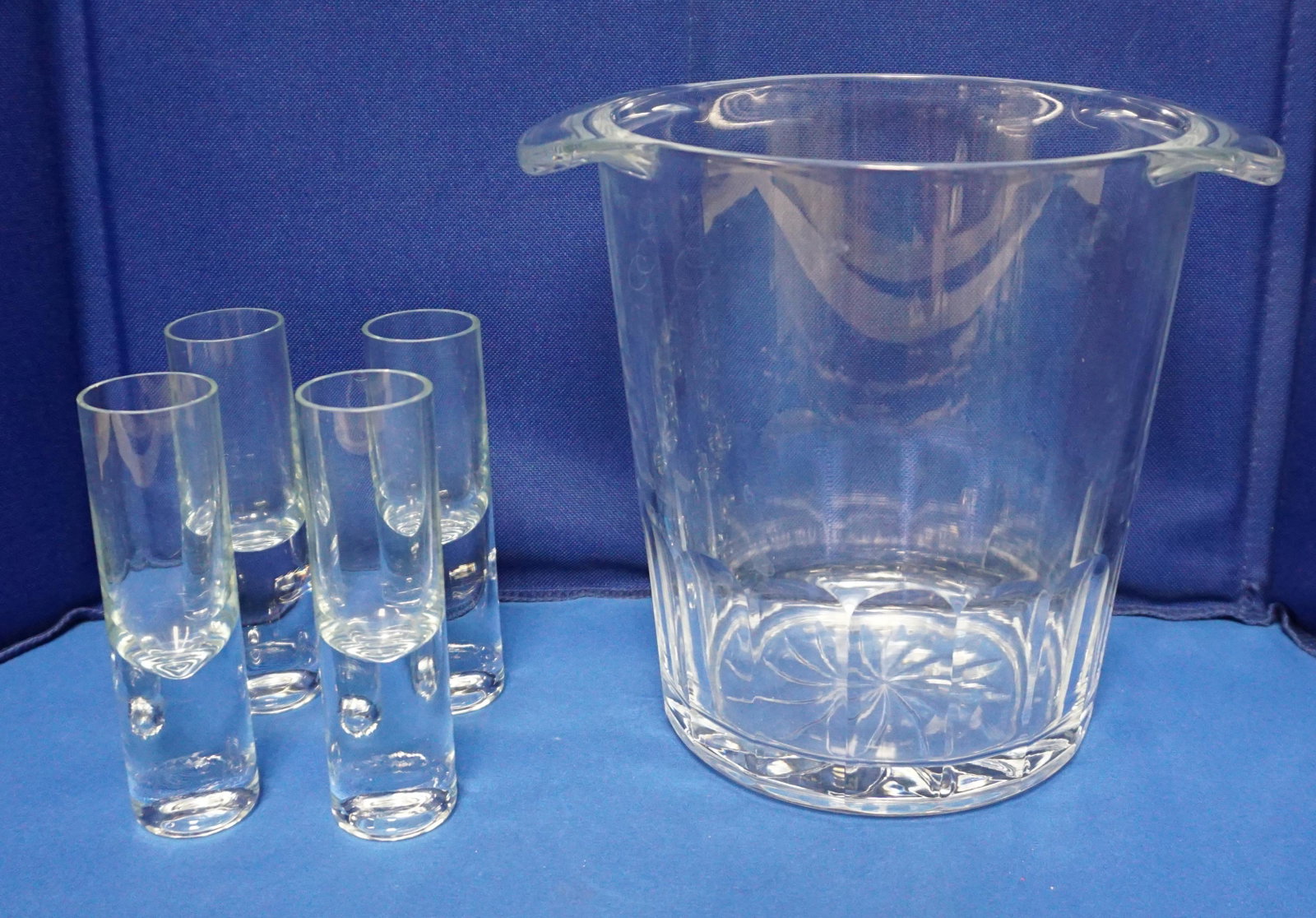 GLASS ICE BUCKET WITH 4 VODKA GLASSES: Cut Glass Ice Bucket 8 1/2"x7 1/2" and 4 Vodka Glasses 5". Weight on all 6 pds 2 oz. PROVENANCE: A Private Charleston SC Estate. Shipping on this item offered through, Pak Mail 843-849-0310 - info@cha