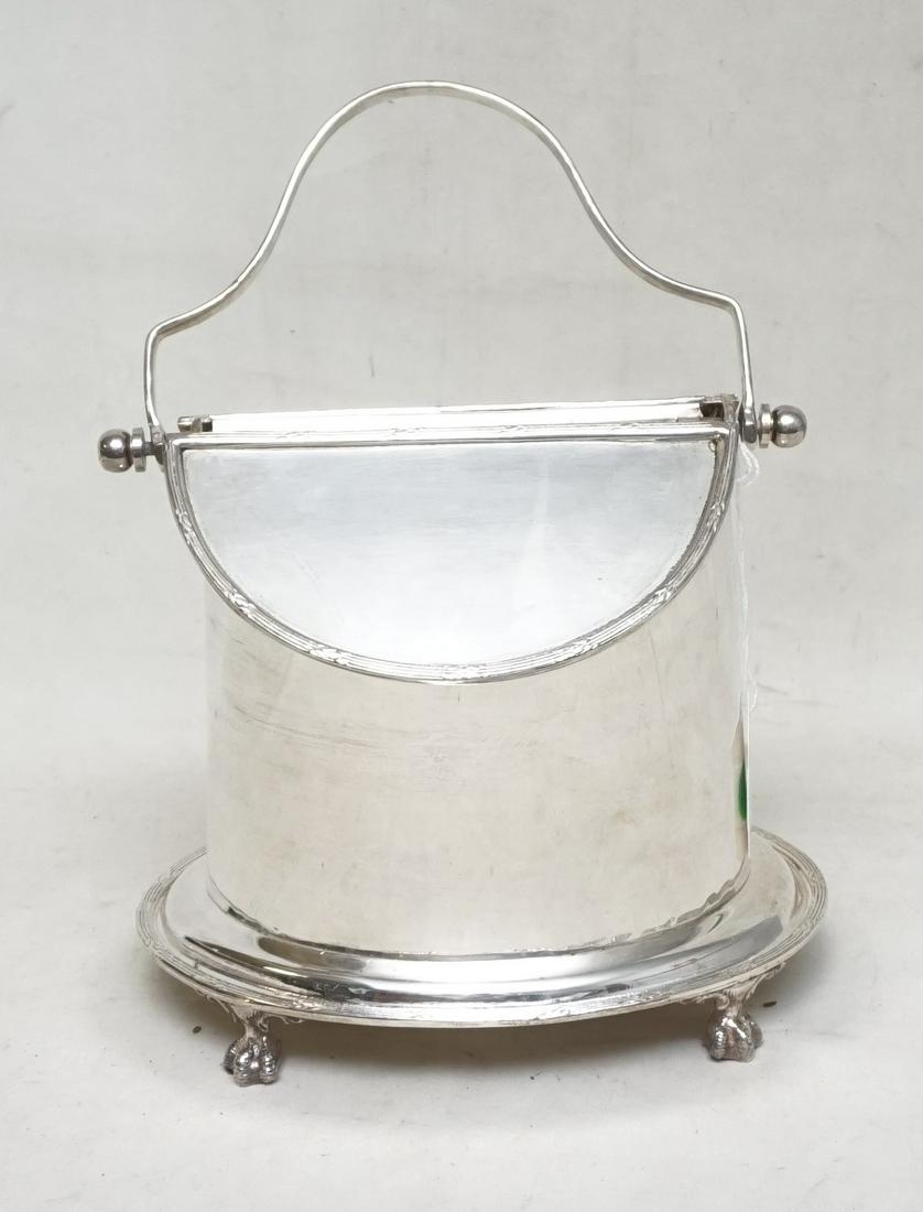 ANTIQUE ENGLISH SHEFFIELD BISCUIT CADDY: Beautiful Antique English Sheffield Regency style biscuit caddy. It has a swing handle that opens a double hinged lid. On Ball and Claw Feet. In great condition. Measures 8"x6"x11". Weight 1pd 13 oz. 
