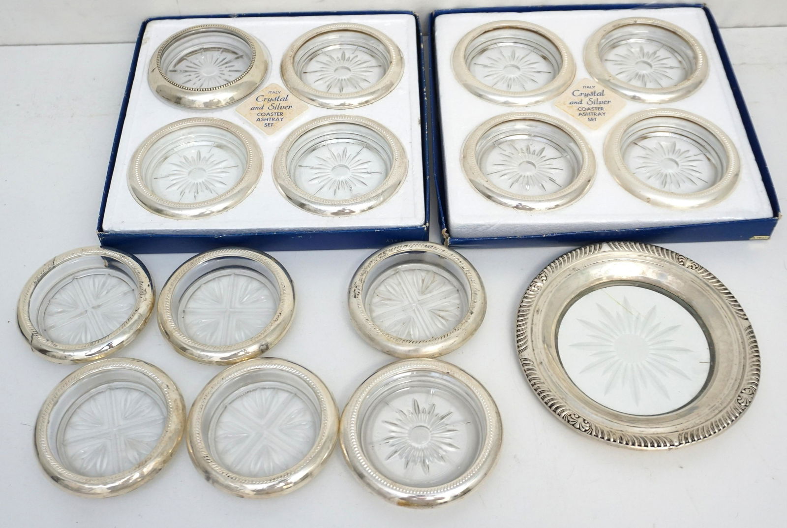 15 pc STERLING & CRYSTAL COASTERS: All crystal/glass with Sterling Silver Rims. 1 Wine Coaster 6" and 14 at 3 3/4". Weight on all 5 pds 5 oz. PROVENANCE: A Private Charleston SC Estate.