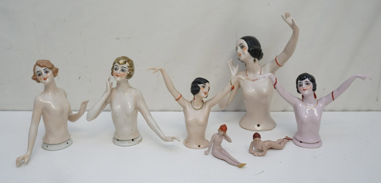 7 ART DECO PORCELAIN NUDES & NUDE HALF DOLLS: 5 Antique / Vintage 1920-30s Art Deco Nude German Porcelain Half Dolls and 2 Miniature Full Nude Bathing Beauties.Tallest 6 1/2". Weight on all combined 1 Pd 9 oz. PROVENANCE: A Private Charleston SC 