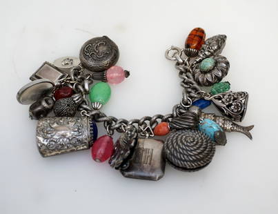 NAPIER 1950S CHARM BRACELET 21 CHARMS: Vintage 1950s Napier charm bracelet having 21 mostly large charms, one German charm marked "800" and two charms marked "Sterling" including one enameled and engraved hinged locket charm with picture