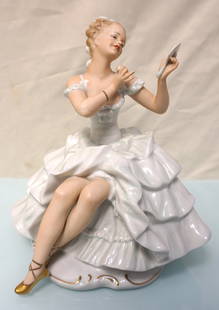 HEINRICH WINTERLING PORCELAIN BALLERINA: Vintage Seated Porcelain Ballerina with powder puff and mirror made by the Heinrich Winterling Porcelain Factory in Germany. With glazed costume, gilt shoes on matte body. Measures 9"x6 1/2"x9 3/4".