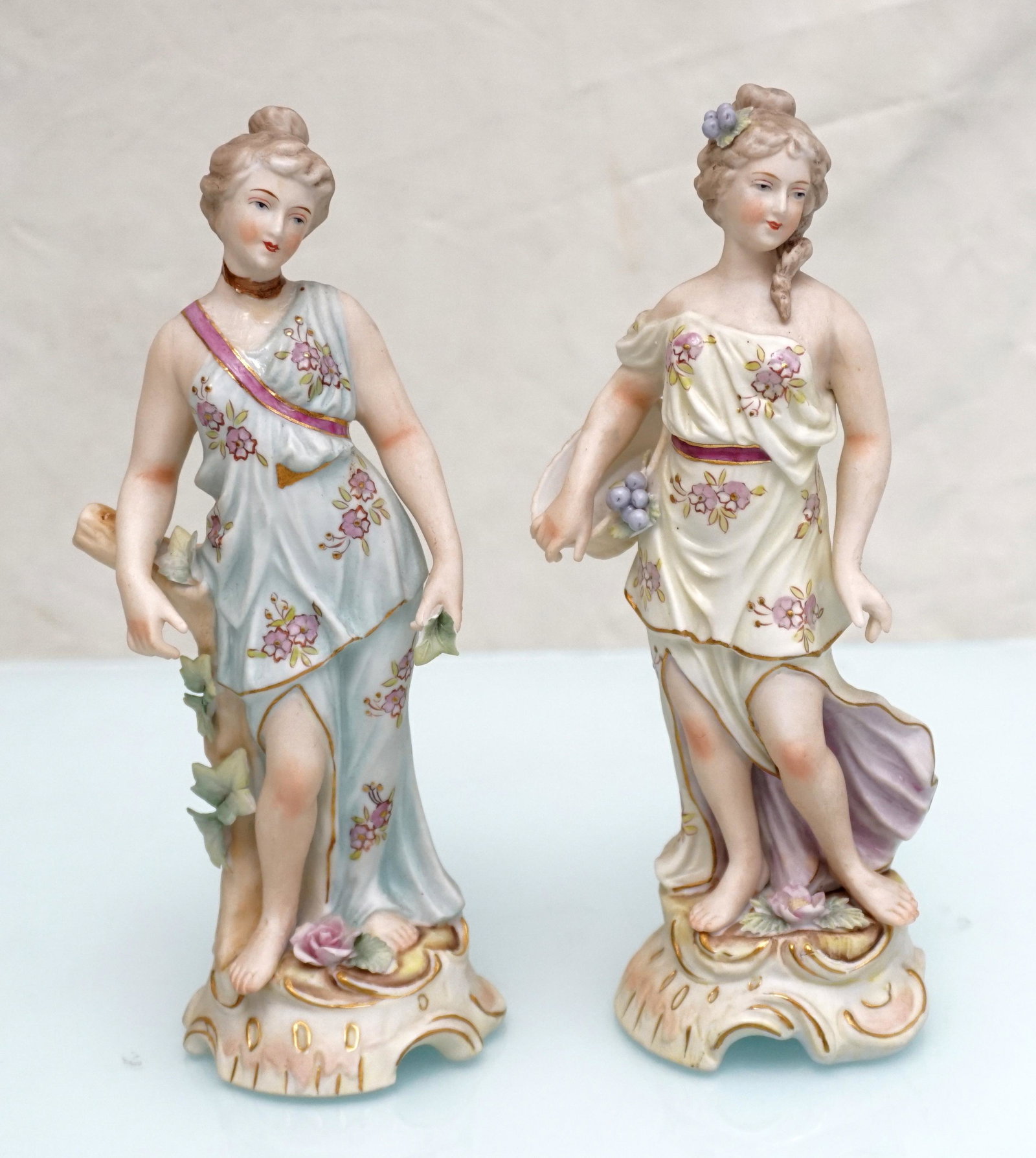 PAIR ARNART PORCELAIN FIGURINES: Pair of Porcelain Classical Maiden Figurines by Arnart Imports. Made in Japan. Each 8" tall. Weight 1 pd 2 oz. PROVENANCE: A Pawleys Island SC Private Estate.