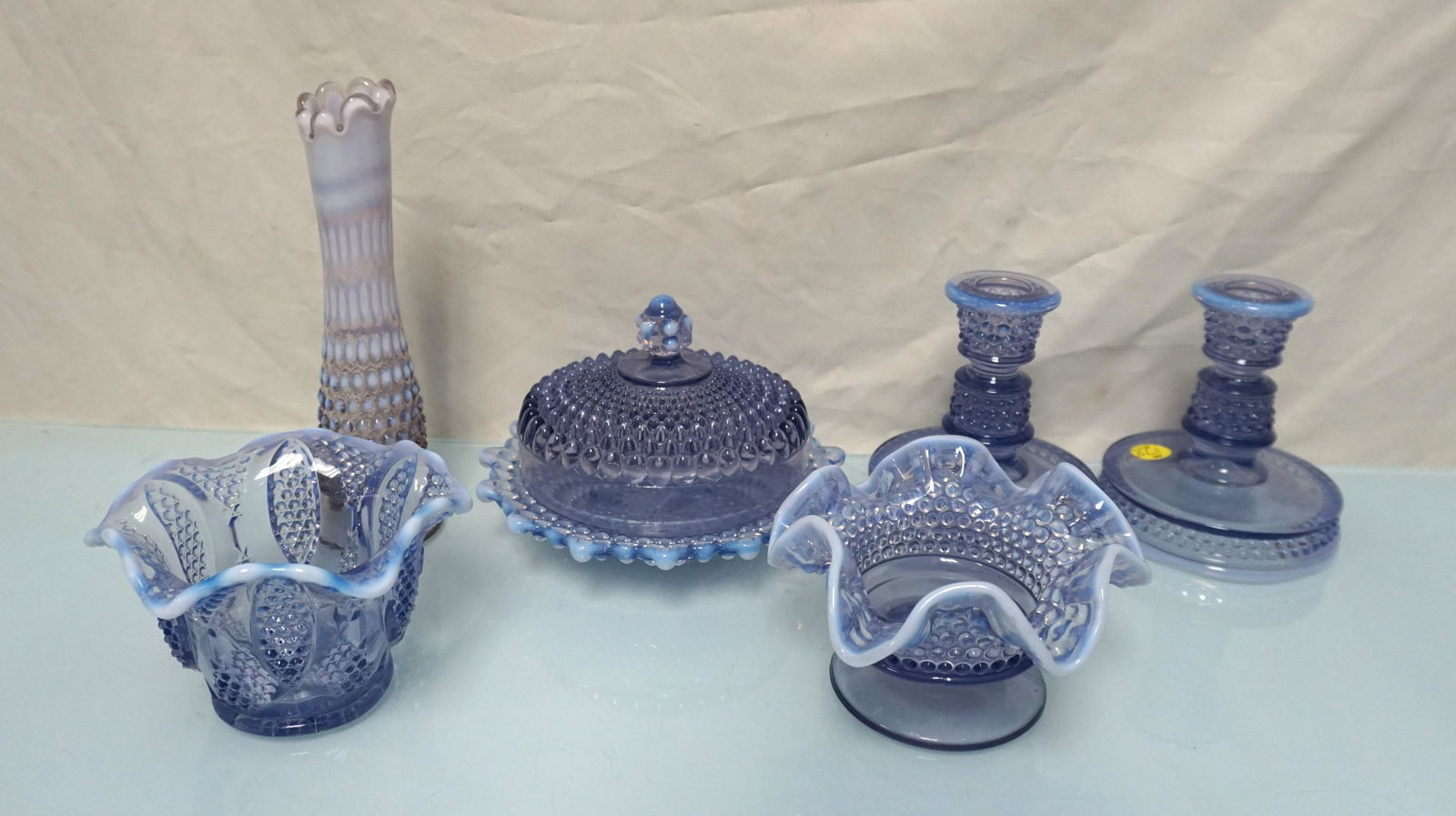 6 WESTMORELAND PURPLE OPALESCENT GLASS: 1- Footed Candy Bowl 5 1//2"x3 tall. 2- Covered Butter 7"x 7 1/2" Tall. 3- Bud Vase 8 1/2". 4- Pair of Candlesticks 4 1/2"x5 1/2". 5- Ruffled Bowl 5"x3/1 2". Weight on all 7 pds. .PROVENANCE: A Charle