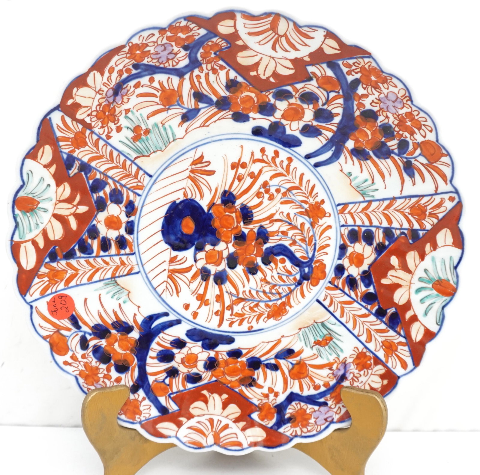 19TH C SCALLOPED EDGE IMARI CHARGER: Colorful Japanese Imari charger with center floral designs in cobalt blue and rust colors. 12" diameter good condition. Weight 2 pds 8 oz. PROVENANCE: A Charleston Private Estate.