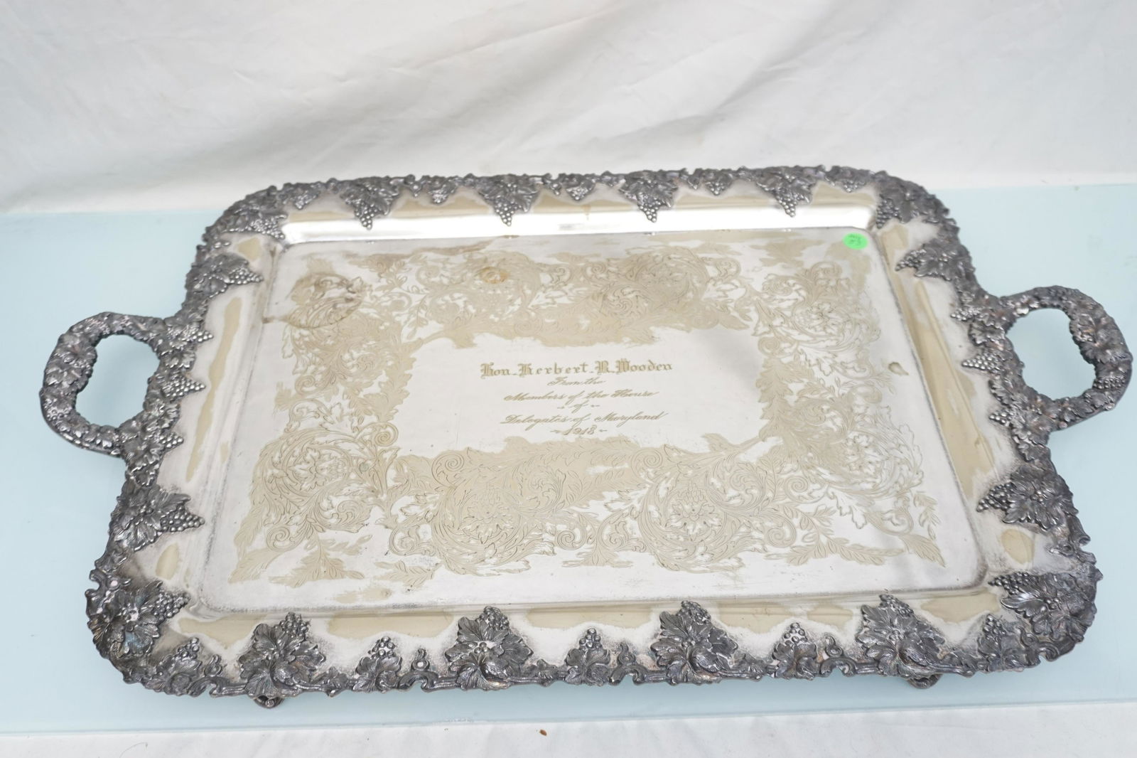 1918 SPEAKER OF THE HOUSE MONUMENTAL BUTLERS TRAY: Monumental Silver Plated Butlers Tray by E.G. Webster. Measures 28"x17". Rococo Etched Flora and Fauna. Handles and Rim covered in Repousse Grapes and Vines. Engraved to the Hon. Herbert R. Wooden, Fr