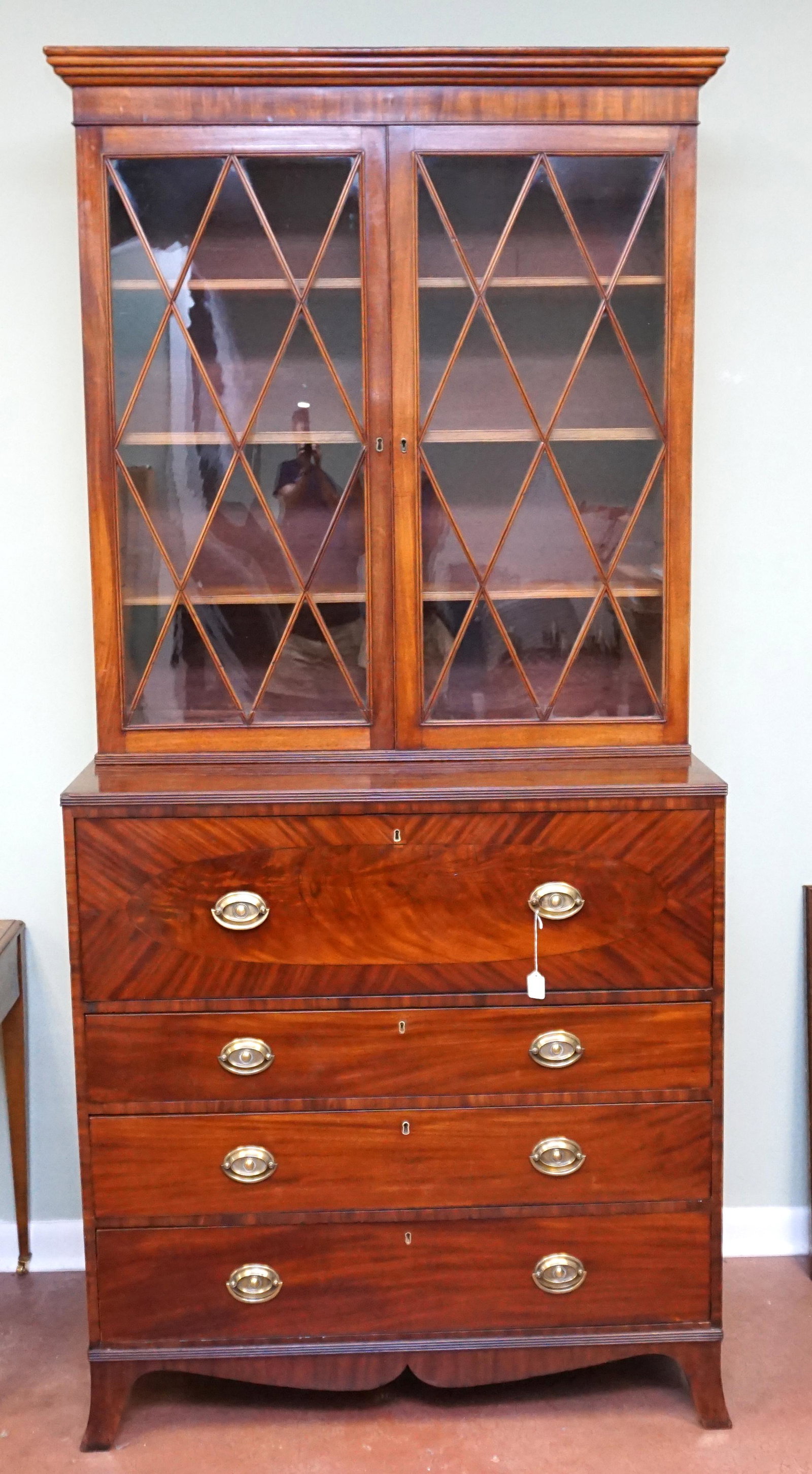 ENGLISH C 1790 MAHOGANY & SATINWOOD FALL FRONT SECRETARY BOOKCASE: English mahogany and satinwood secretary bookcase with a carved molded edge cornice, flanking hinged glass doors revealing adjustable interior shelving, fall front desk with leather writing surface, s
