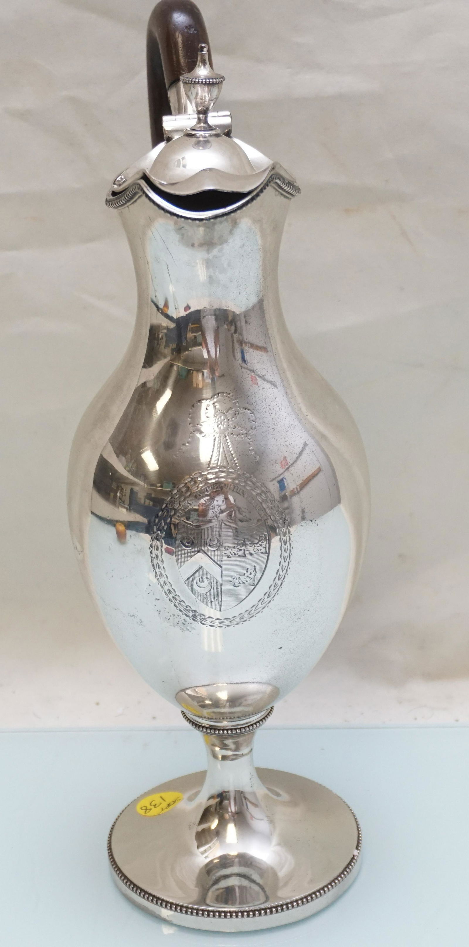 GEORGE III STERLING SILVER WINE EWER: George III Sterling Silver Wine Ewer. The body of ovid form raised upon a circular pedestal foot with a beaded rim, the waisted neck with a hinged lid of conforming shape surmounted by a urn finial. W