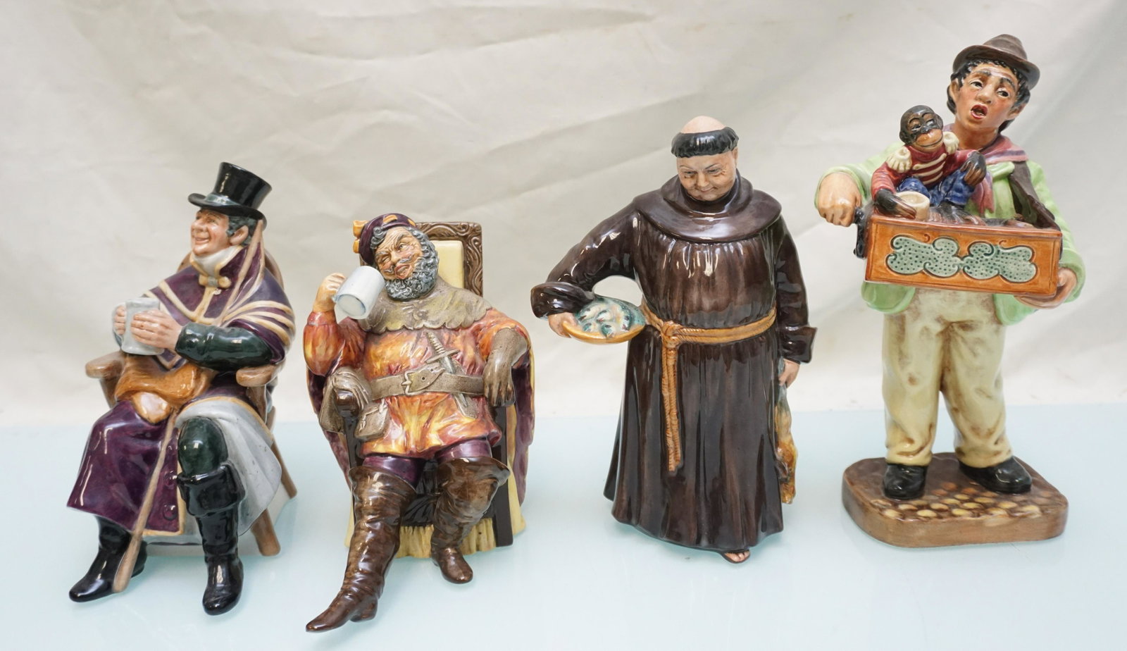 4 VINTAGE ROYAL DOULTON FIGURINES: 1- Organ Grinder HN 2173, 1953. 2- The Foaming Quart HN 2162, 1954. 3 - The Jovial Monk HN 2144, 1953. 4- The Coachman HN 2282, 1962. Weight on all combined 4 pds 6 oz.