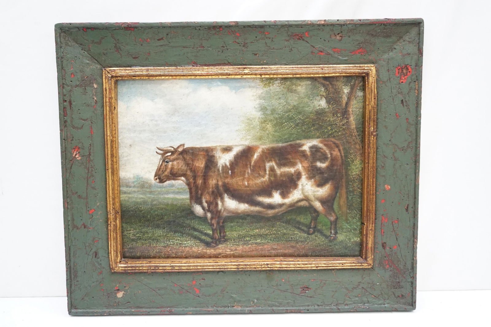 TREVOR JAMES OIL ON CANVAS COW IN FIELD: Trevor James (American, 20th c.) Oil on Canvas Cow in Field. In Green Wood distressed Frame. In frame measures 22 1/2"x18 1/2"z1 1/2". Weight 4 pds 8 oz. PROVENANCE: A Charleston SC Private Estate.