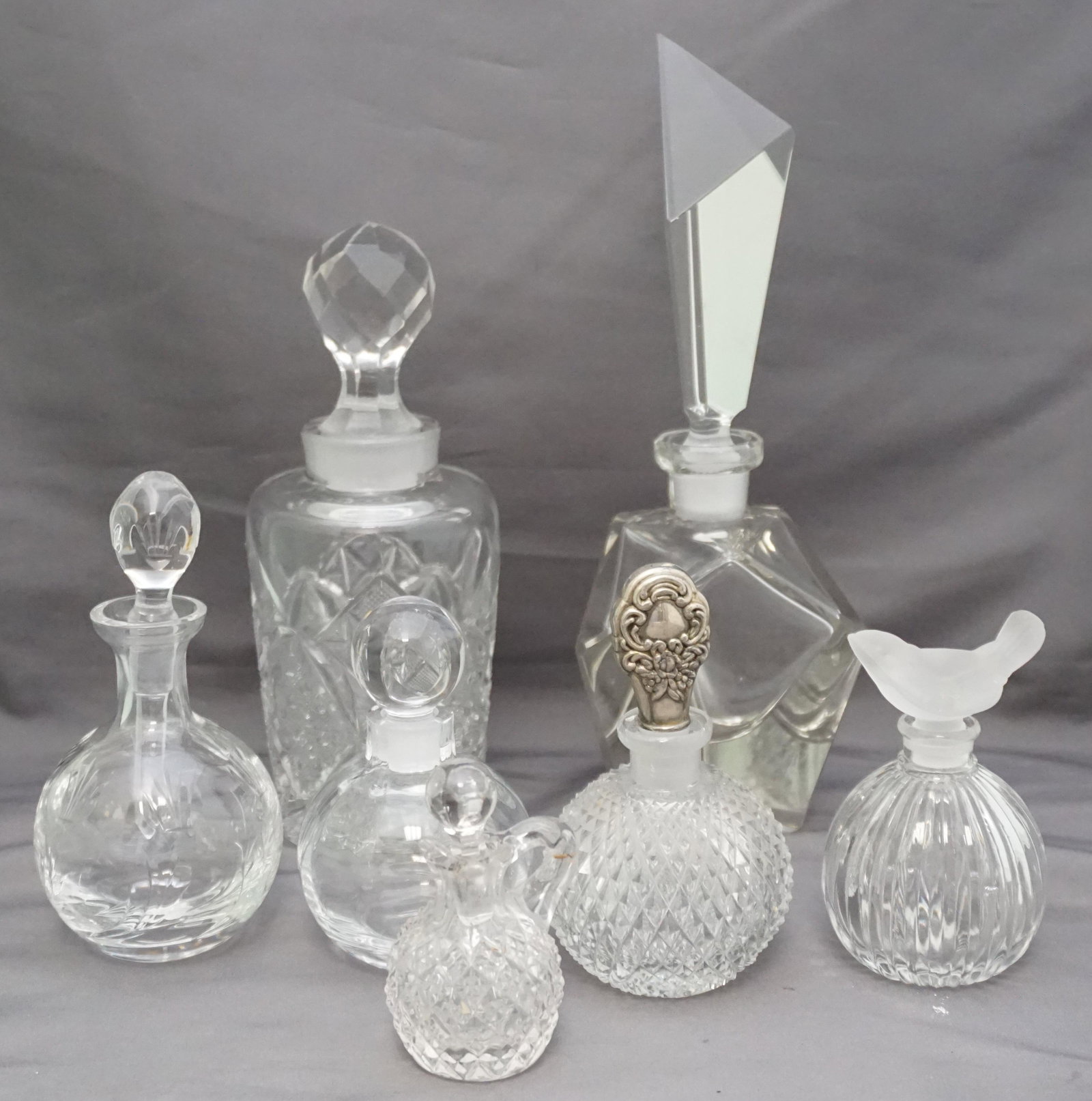 7 pc VINTAGE GLASS / CRYSTAL PERFUME / COLOGNES: 6 Vintage Glass / Crystal Perfume / Colognes and 1 Miniature Cruet. Tallest Art Deco Style 9". Weight on all 3 pds 9 oz. PROVENANCE: A Private Charleston SC Estate.