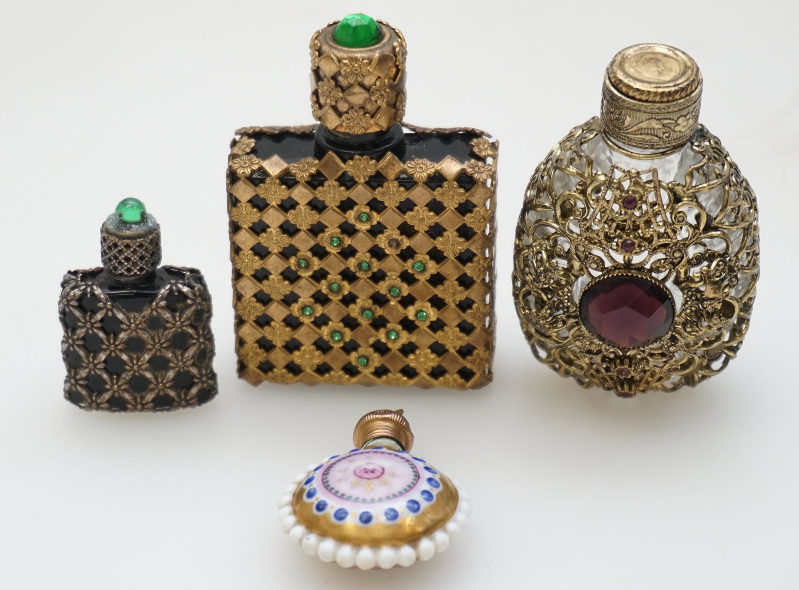 4 VINTAGE FRENCH & CZECH PERFUMES: 4 Vintage Czech and French Perfumes. Includes a Porcelain enameled small to be worn as a pendant 1 1/2". Largest 2 1/2". Weight on all 4 oz. PROVENANCE: A Private Charleston SC Estate