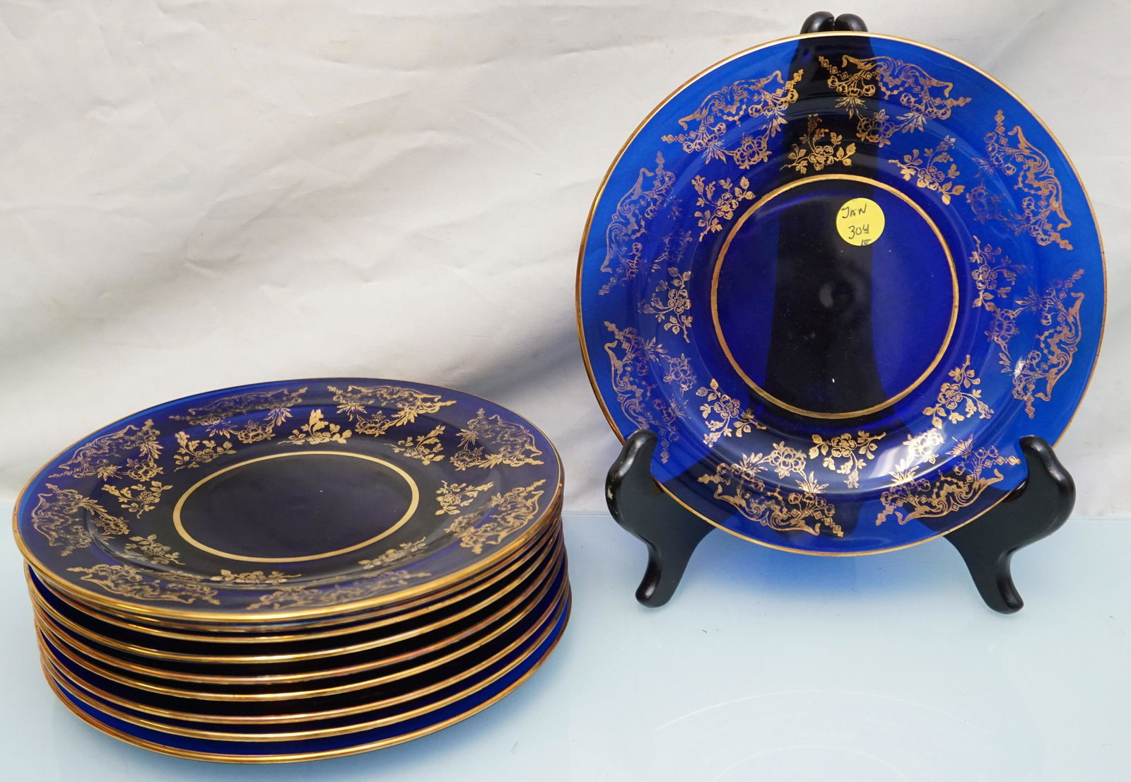10 COBALT & GILT ELEGANT ERA GLASS PLATES: 10 Elegant Era Cobalt and Gilt Glass Luncheon / Dessert Plates. Each 8 1/8". Weight 7 pds 5 oz. PROVENANCE: A Private Charleston SC Estate.