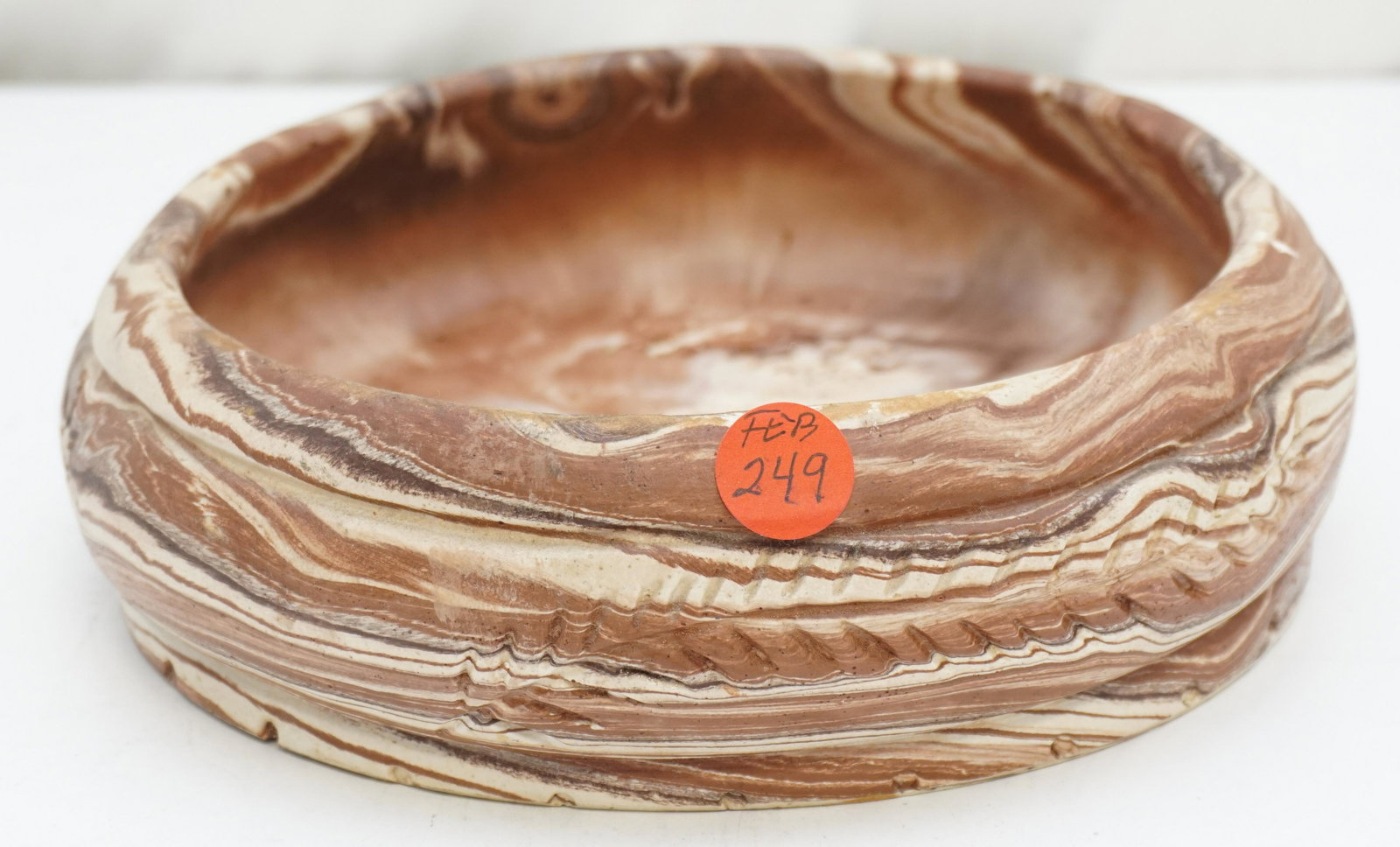 VINTAGE COMANCHE POTTERY BOWL: Vintage Comanche Pottery Bowl. Comanche Pottery was a brand owned by Ron Allen. Ron Allen (in 1934) and his brother were born in Comanche, Texas. Measures 8 1/4"x8 1/2"x2". Weight 3 pds. PROVENANCE: A