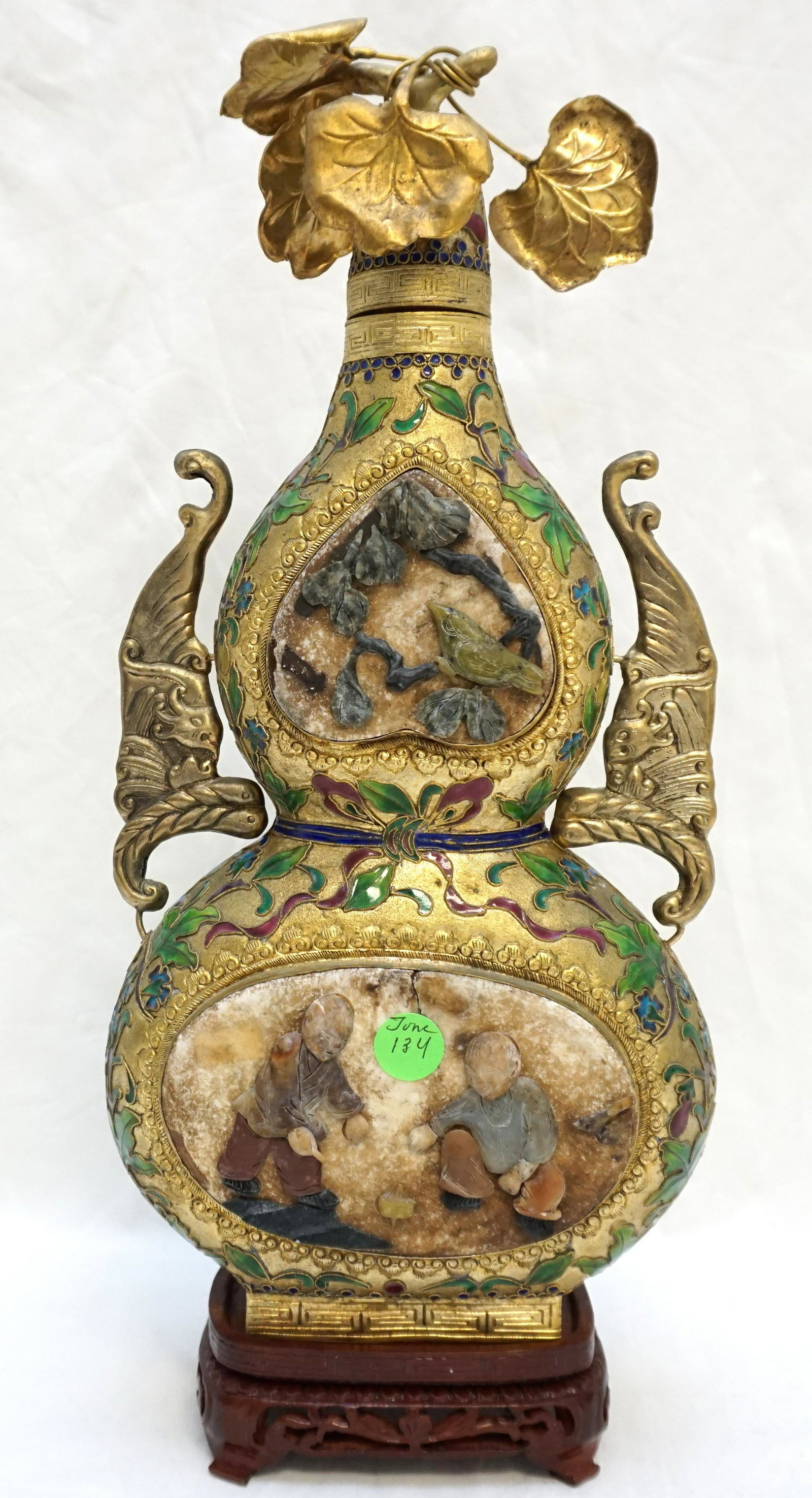 CHINESE GOLD CLOISONNE & SOAPSTONE DECANTER: Large Chinese Gilt Metal Cloisonne Wine Decanter with inlaid carved soapstone children and birds on ornate carved stand. 16" tall on stand. Weight 3 pds 3 oz.