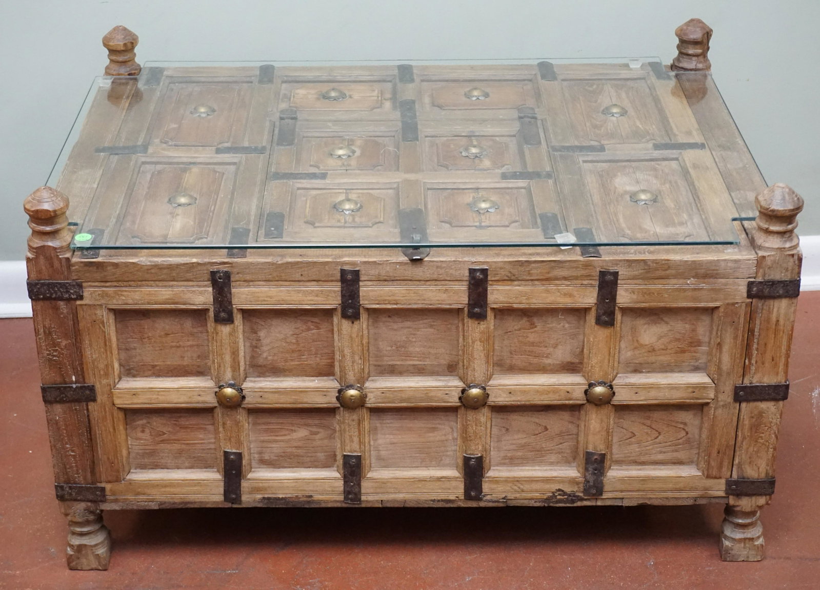 MOROCCAN CHEST / TABLE WITH IRON AND BRASS ACCENTS: Antique Moroccan Chest with Iron and Brass Accents. Topped with custom cut glass for use as a table. 36"x25"x21". PROVENANCE: A Private Charleston SC Estate. NO IN HOUSE SHIPPING. *******Pickup or Shi