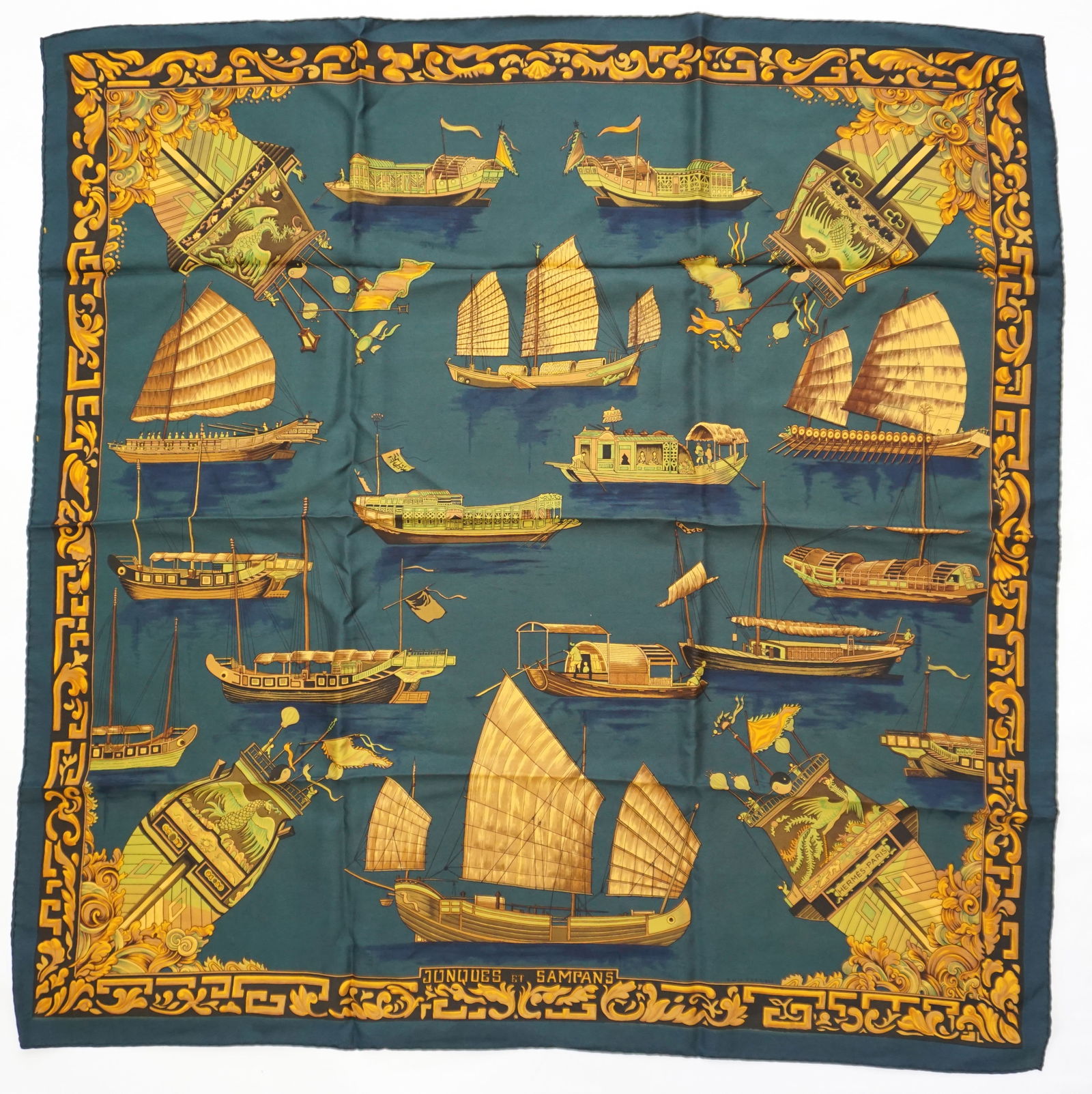 HERMES PARIS "JONQUES ET SAMPANS" SILK SCARF: HERMES PARIS silk "Jonques et Sampans" scarf. The scarf features drawings of traditional Junks and Sampans from various Asian countries in shades of gold with chartreuse details. The scarf setting is