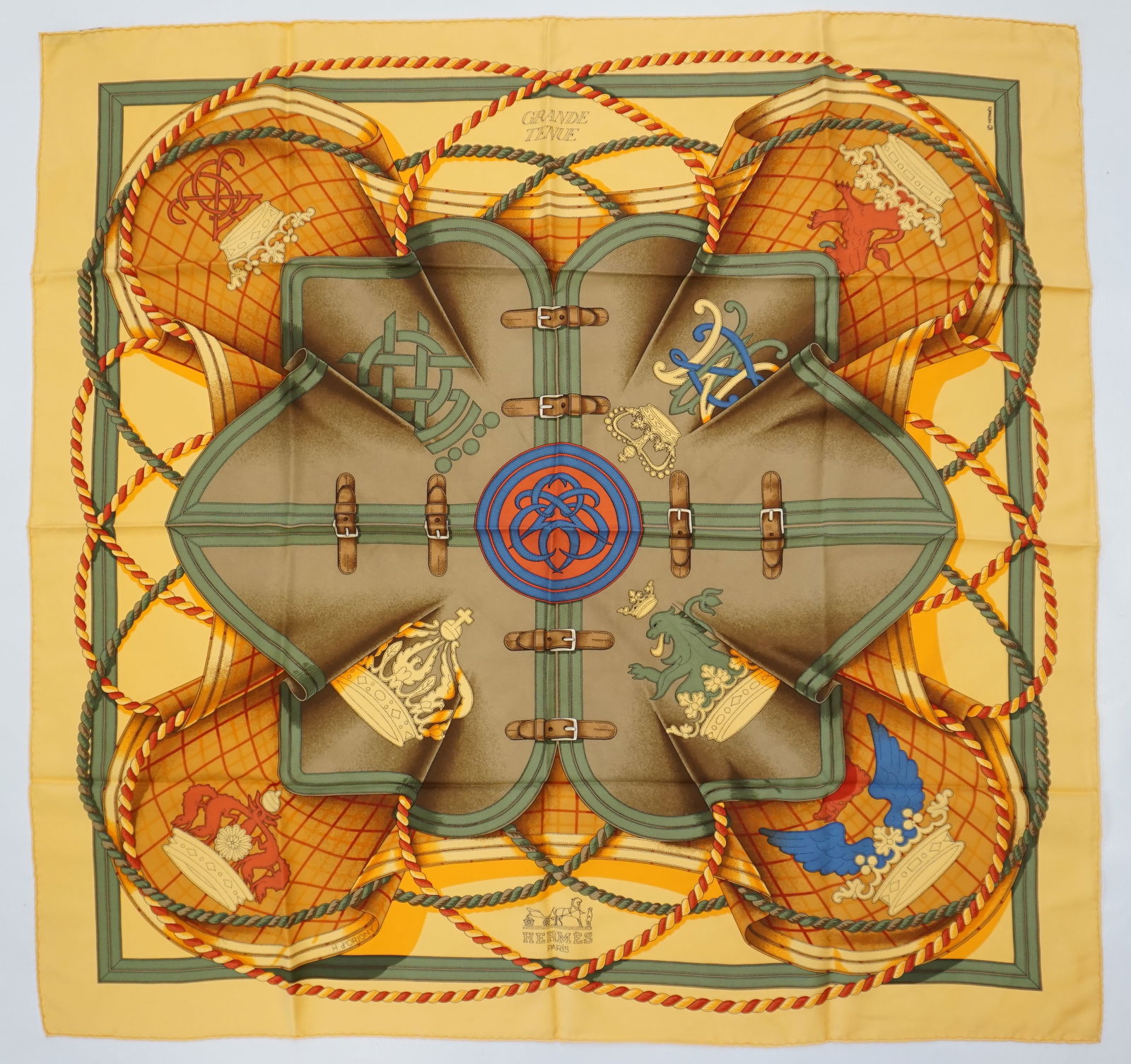 HERMES PARIS "GRANDE TENUE" SILK SCARF: HERMES PARIS silk “Grande tenue” scarf. The scarf has a center design in taupe green with gold crowns, royal symbols and is accented with rope designs. It has a vibrant yellow and orange b
