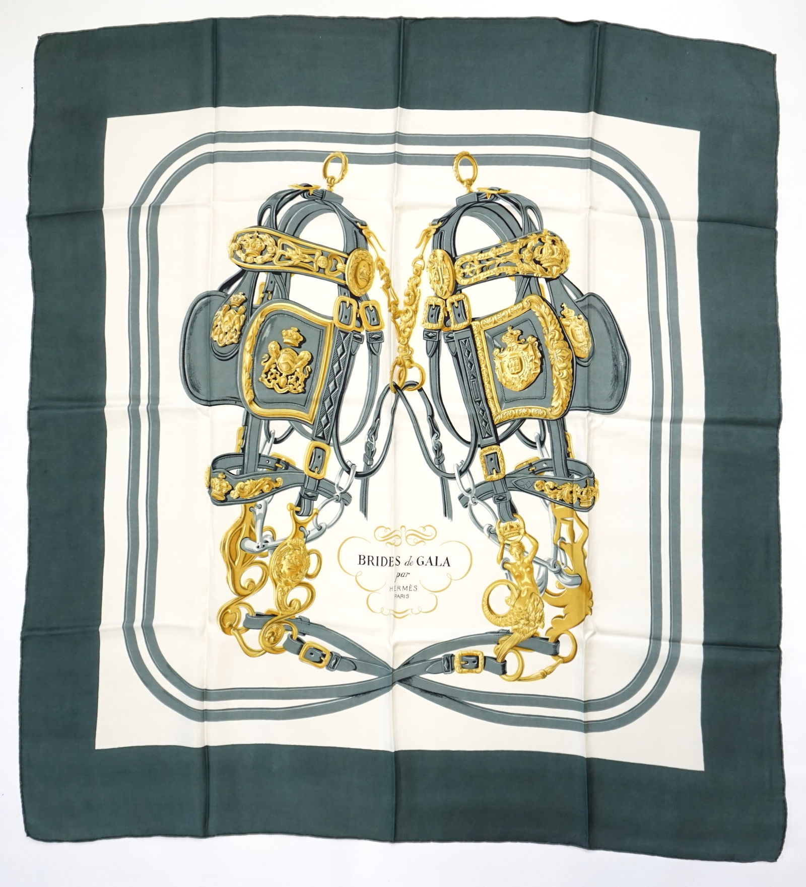 HERMES PARIS "BRIDES DE GALA" SILK SCARF: HERMES PARIS silk “Brides de Gala” scarf. The scarf features a symmetrical arrangement of intricately detailed bridles, bits, and harnesses, woven together with minimalistic colors, here i