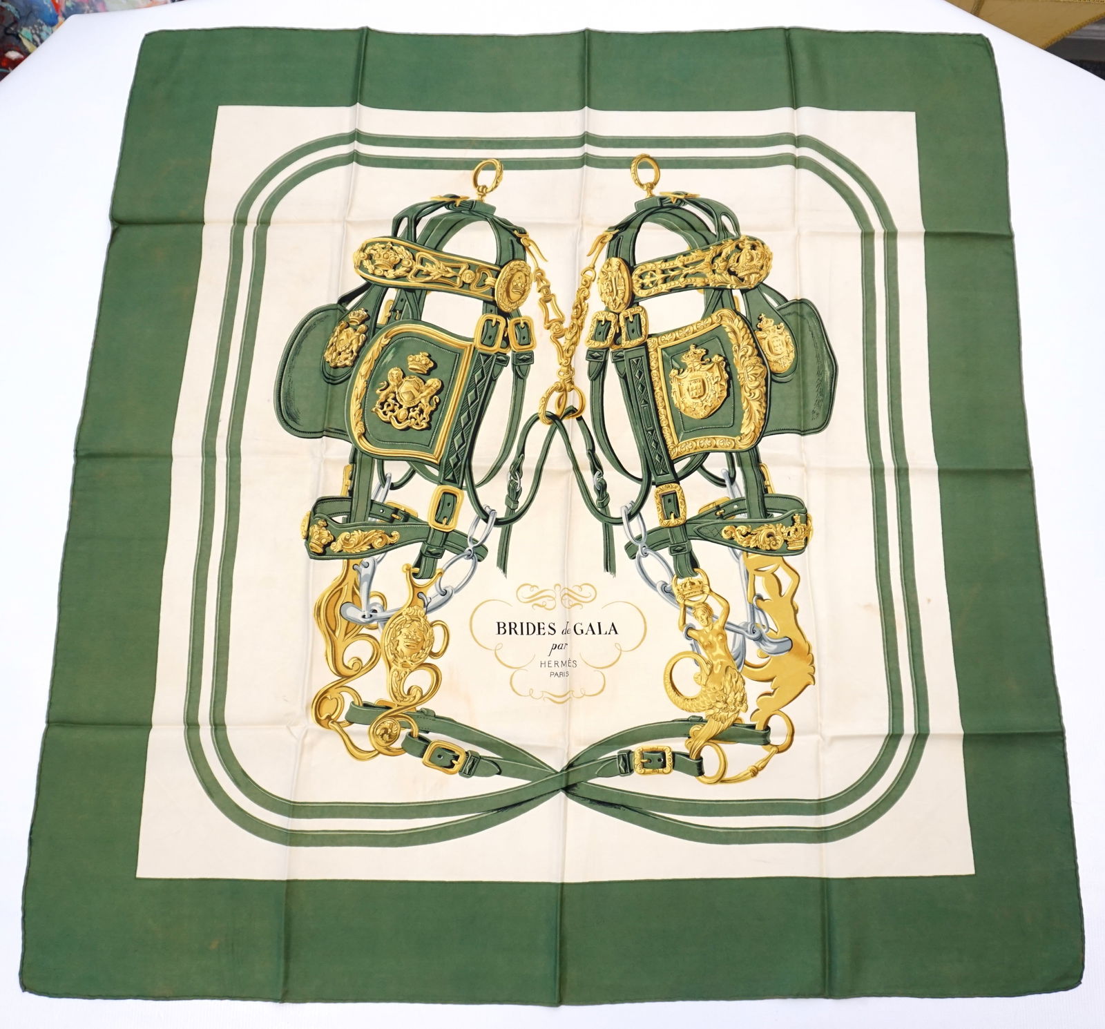 HERMES PARIS "BRIDES DE GALA" SILK SCARF: HERMES PARIS silk “Brides de Gala” scarf. The scarf features a symmetrical arrangement of intricately detailed bridles, bits, and harnesses, woven together with minimalistic colors, here i