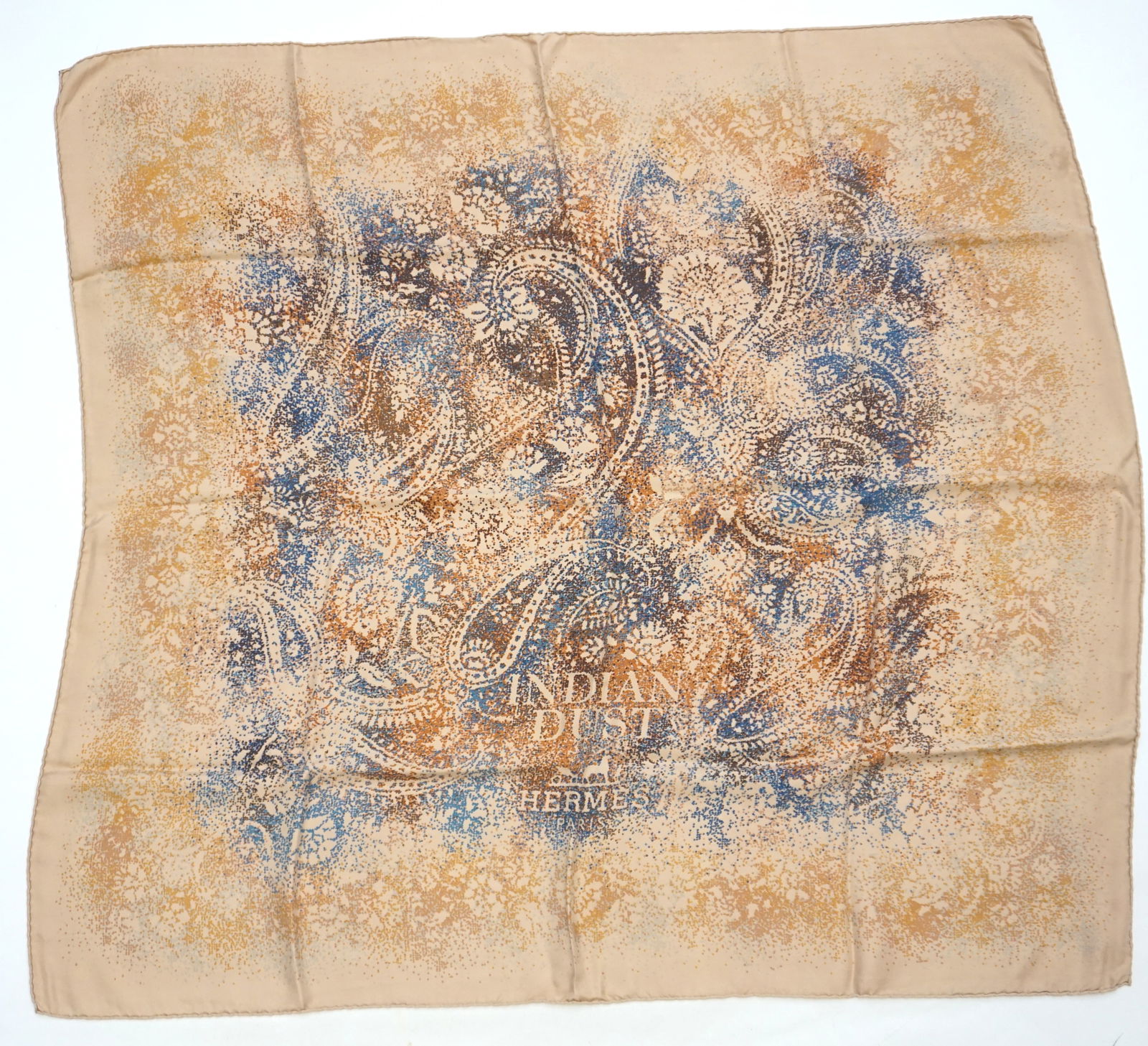 HERMES PARIS "INDIAN DUST" SILK SCARF: HERMES PARIS silk “Indian dust” scarf. The scarf features a center dust motif in shades of blue, caramel and brownish yellow allowing “Indian Dust Hermes Paris” to be drawn in