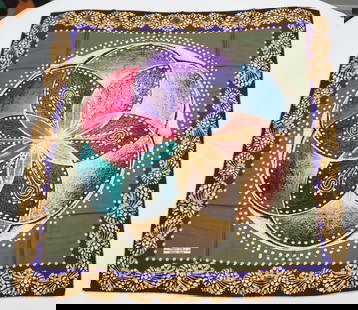 VERSACE 1969 SILK SCARF: VERSACE 1969 silk scarf featuring a floral pattern in muted tones including pink blue purple over a green background framed by golden jewels depictions. Sewn in tag present. The scarf measures approxi