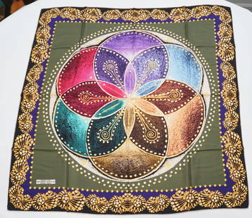 VERSACE 1969 SILK SCARF: VERSACE 1969 silk scarf featuring a floral pattern in muted tones including pink blue purple over a green background framed by golden jewels depictions. Sewn in tag present. The scarf measures approxi