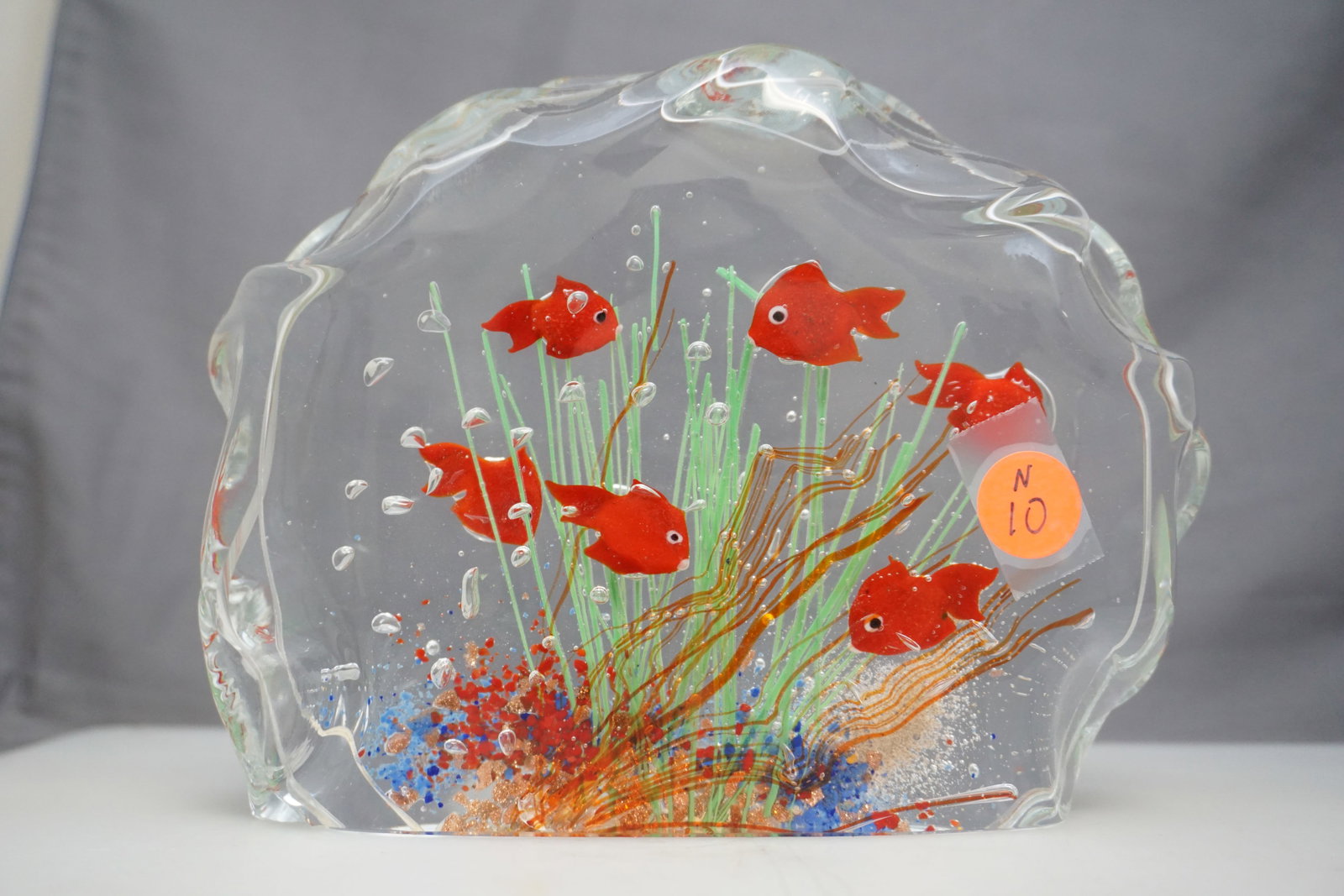 MURANO GLASS FISH AQUARIUM SCULPTURE: Vintage Murano hand blown glass fish aquarium sculpture. The piece has a free form design with red fish suspended amidst multi color seagrass and coral. Murano label present on base, measures 8x6x2", 