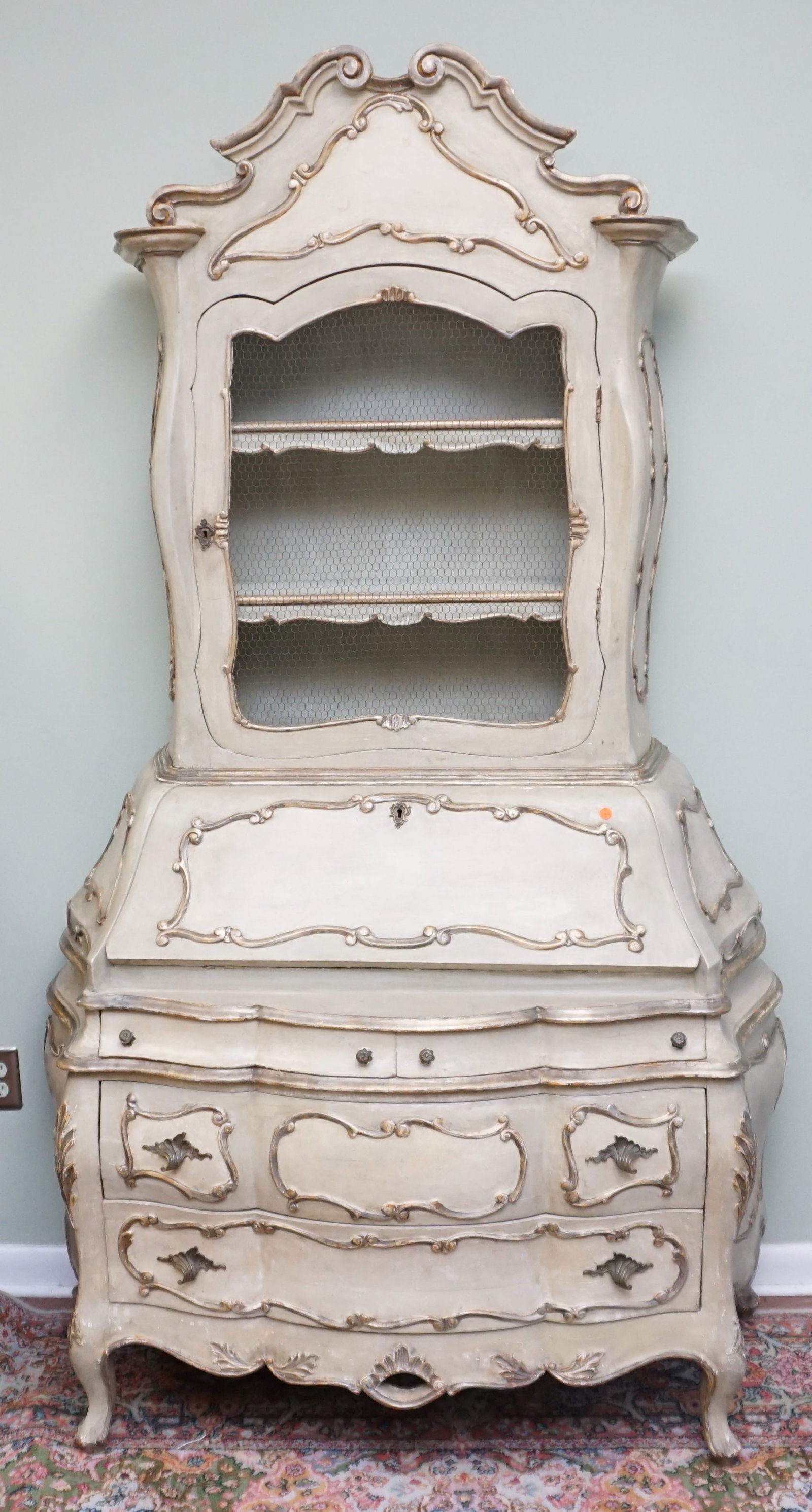 FRENCH ROCOCO STYLE SECRETARY: This exceptional piece of vintage reproduction furniture has every detail of pieces original to the period. The top portion is open with a braded wire door below which sits a fold down secretary with 