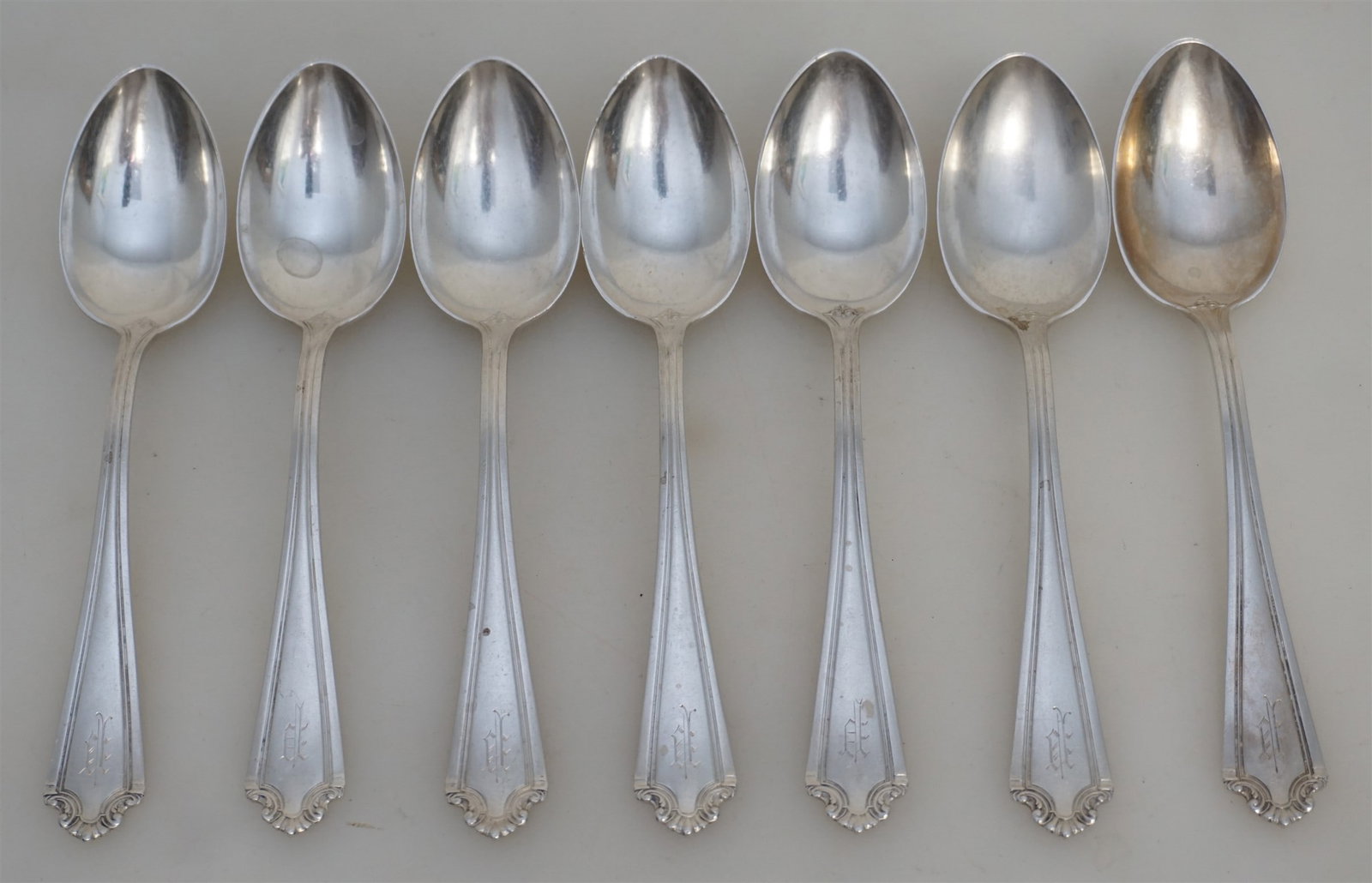 7 STERLING ST. GEORGE TEASPOONS: Seven Sterling Silver Reed & Barton St. George c. 1918 Teaspoons 5 7/8" All monogrammed. Approximate Weight 180 grams. PROVENANCE: Edwin Moore Brogdon, PhD, collection. Dr. Brogdon was the owner of Br