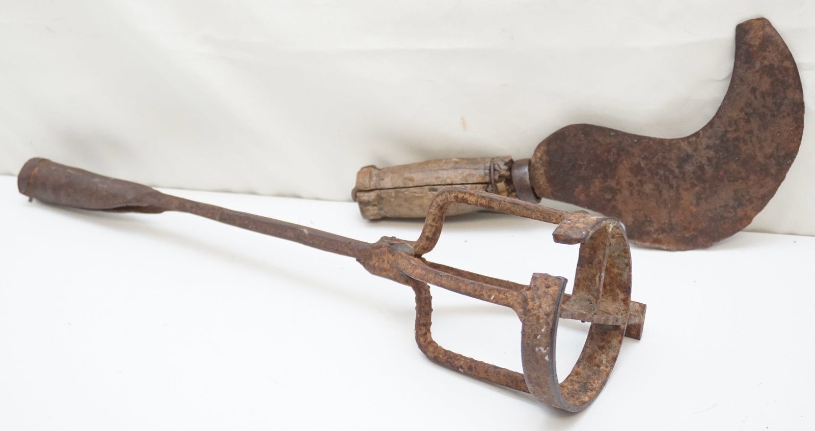 FARMING HERITAGE HAND ROT BRAND AND SICKLE SET: This set features two agricultural implements: a hand rot brand and a hand sickle. The brand, which measures 17" long, would have been used for marking, while the sickle, 11.5" long, was a tool for cu