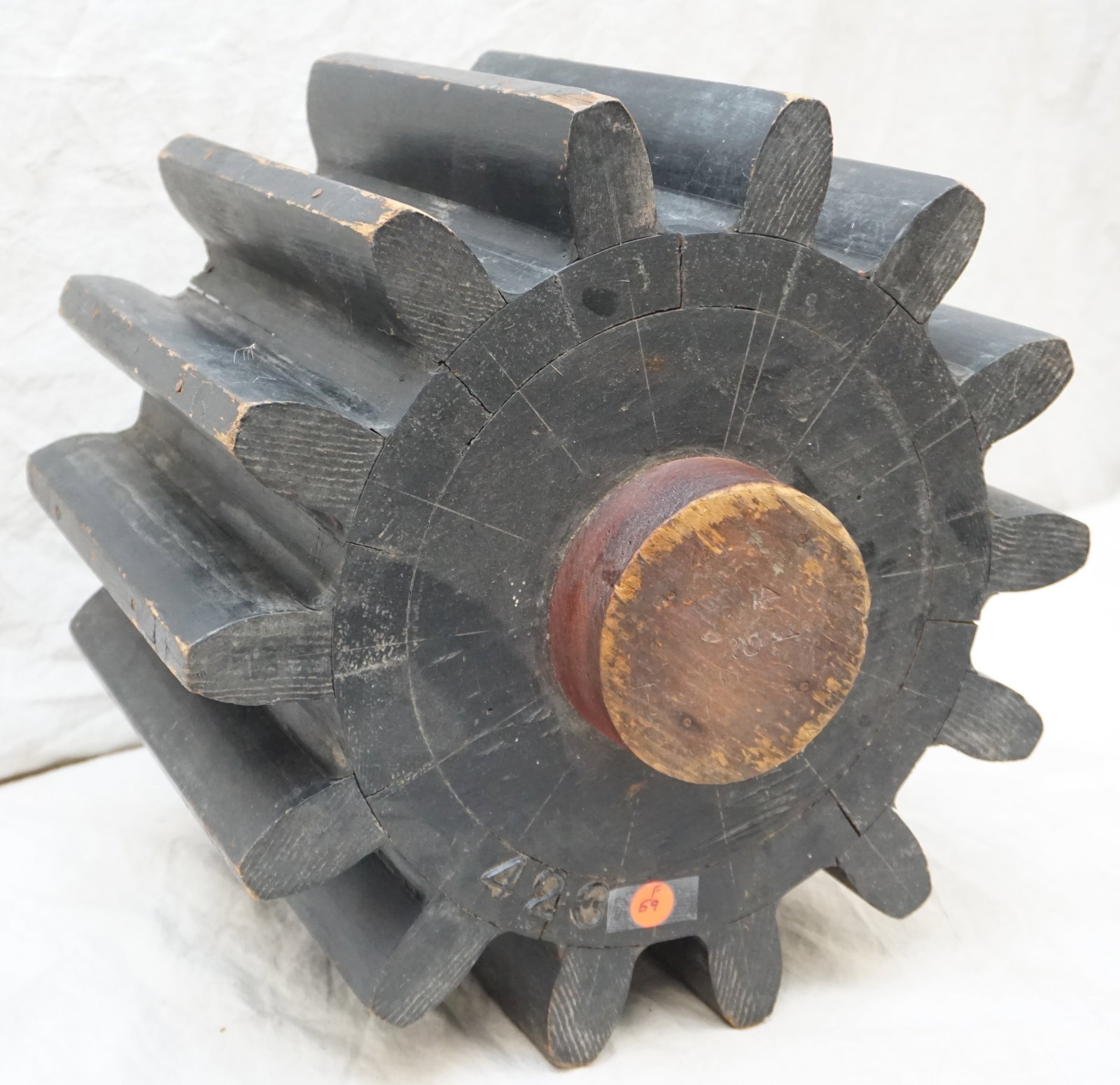 INDUSTRIAL WOODEN GEAR MOLD #423: This vintage wooden industrial gear mold, etched with the number "423," bears the marks of heavy use. Such molds were once central to the manufacturing of gears, and this particular piece's size and s