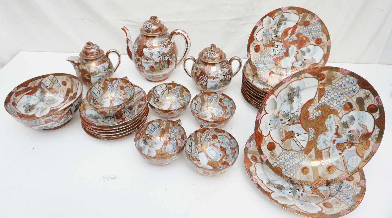 GREAT JAPAN SHIMIZU TEA SET: The set comprises nine delicate plates, measuring 7.25", two slightly larger plates at 8.5", and one 6" bowl, ideal for sugar or condiments. Six saucers at approximately 5.25" accompany five teacups, 