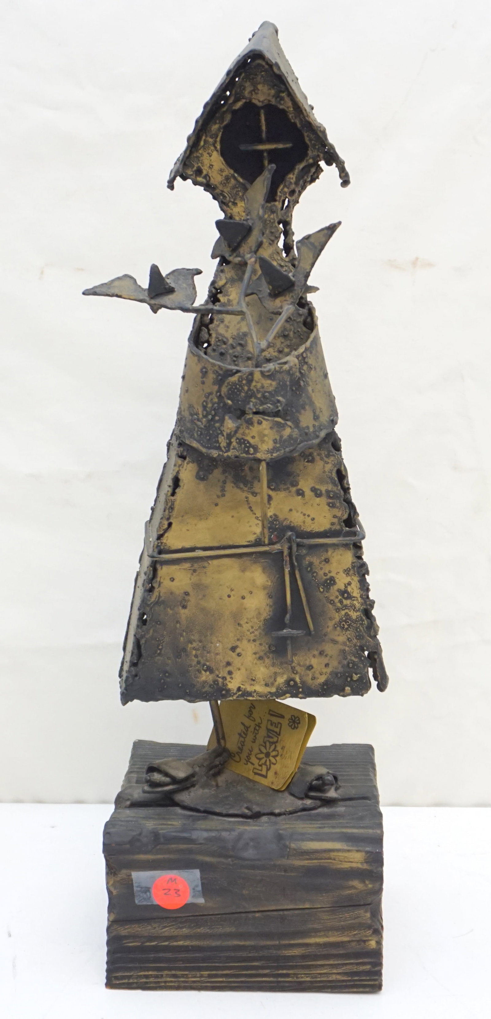 ST. FRANCIS BRUTALIST SCULPTURE BY JACK HANSON: Jack Hanson's Brutalist Sculpture of St. Francis of Assisi, prominently crafted in a raw, abstract form, mounted on a wood base. Measuring 20" high and weighing 5 lbs 3 oz, this commanding piece refle