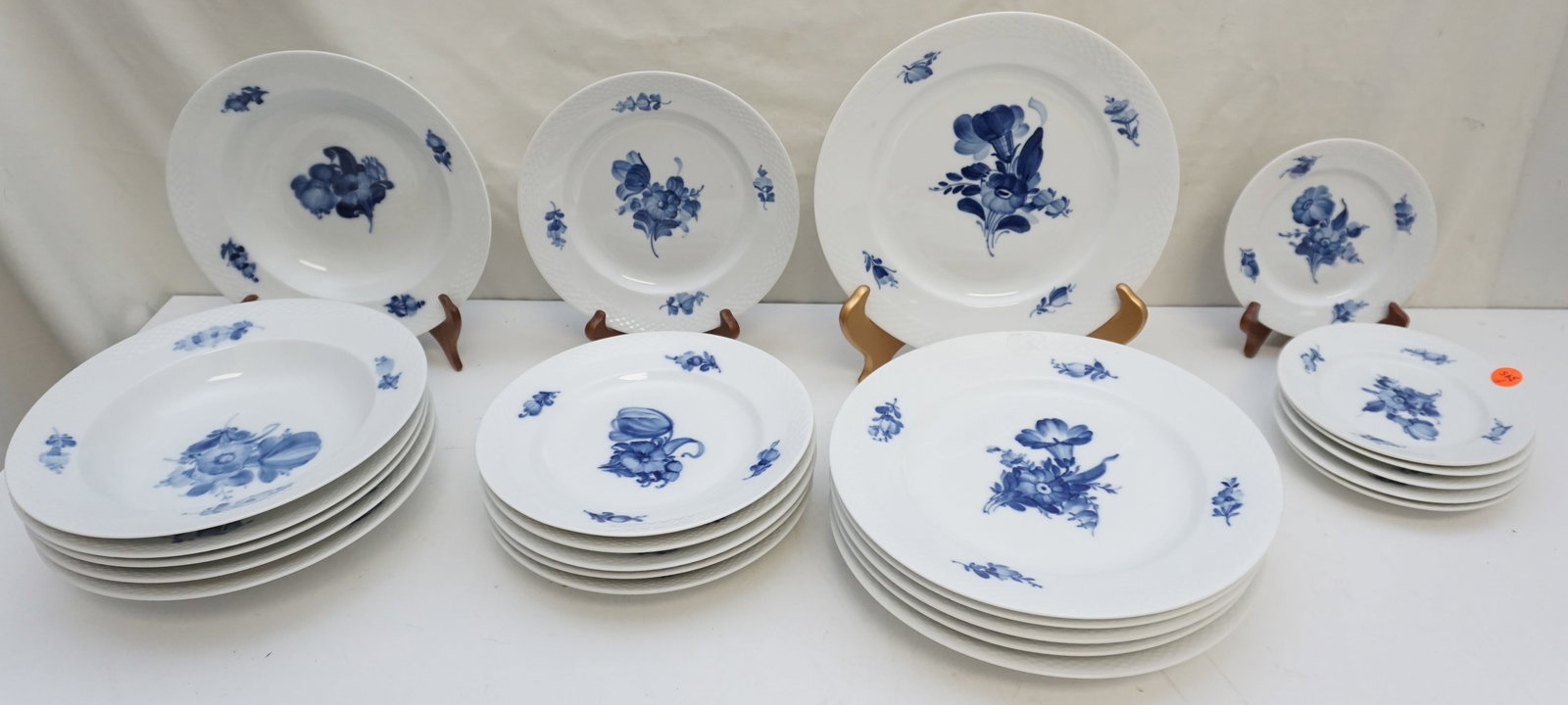 24PC ROYAL COPENHAGEN BLUE FLOWER BRAIDED SERVICE FOR 6: This exquisite 24-piece Royal Copenhagen Blue Flower Braided service for six exudes timeless elegance. The set includes six of each: dinner plates measuring approximately 10.25" across, soup bowls mea
