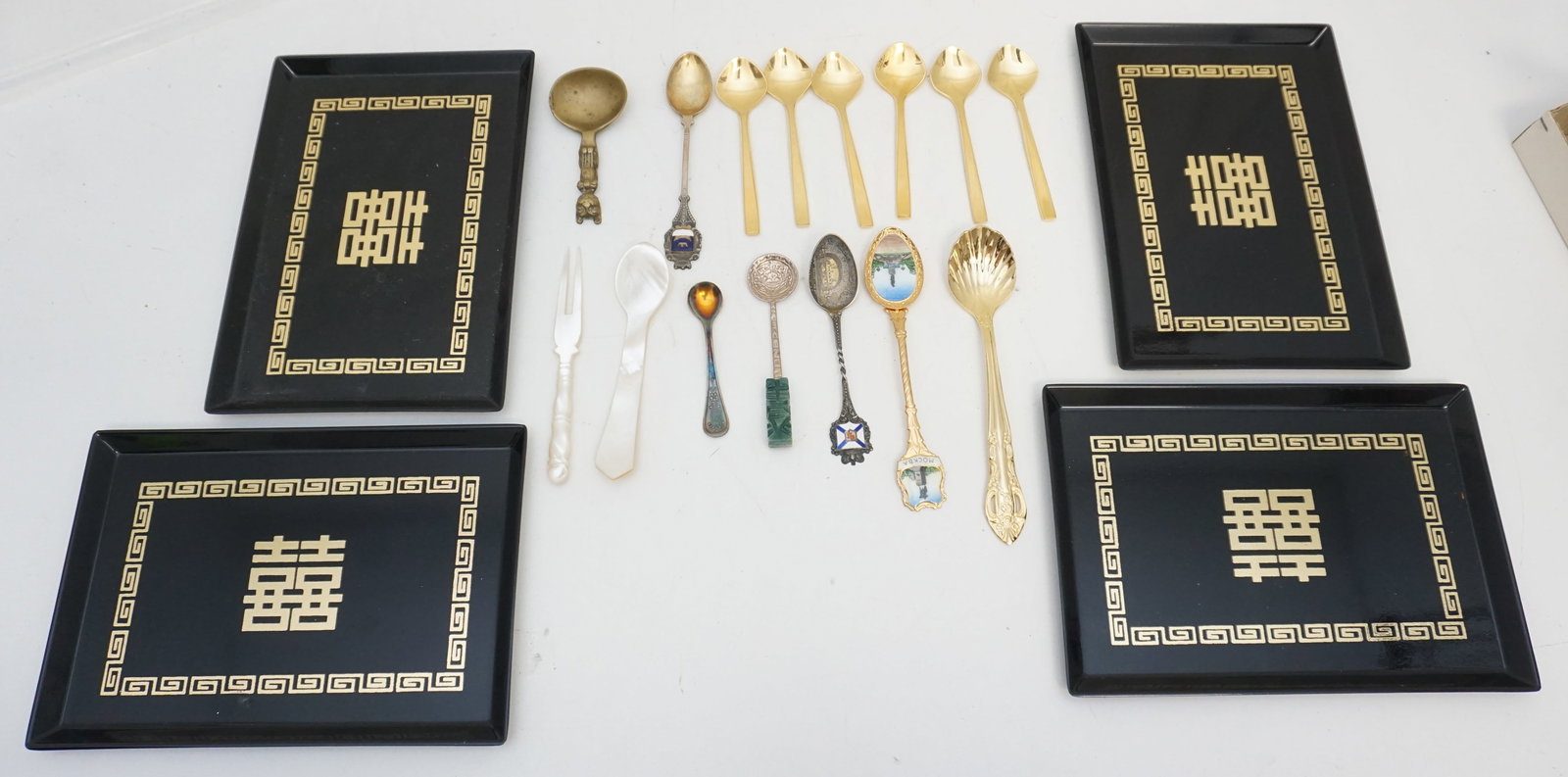 SOUVENIR SPOONS: Eclectic Collection of Souvenir Spoons and Japanese Plates: Assortment includes finely crafted souvenir spoons and four sleek black Japanese rectangular plates. Ideal for collectors and enthusiasts of