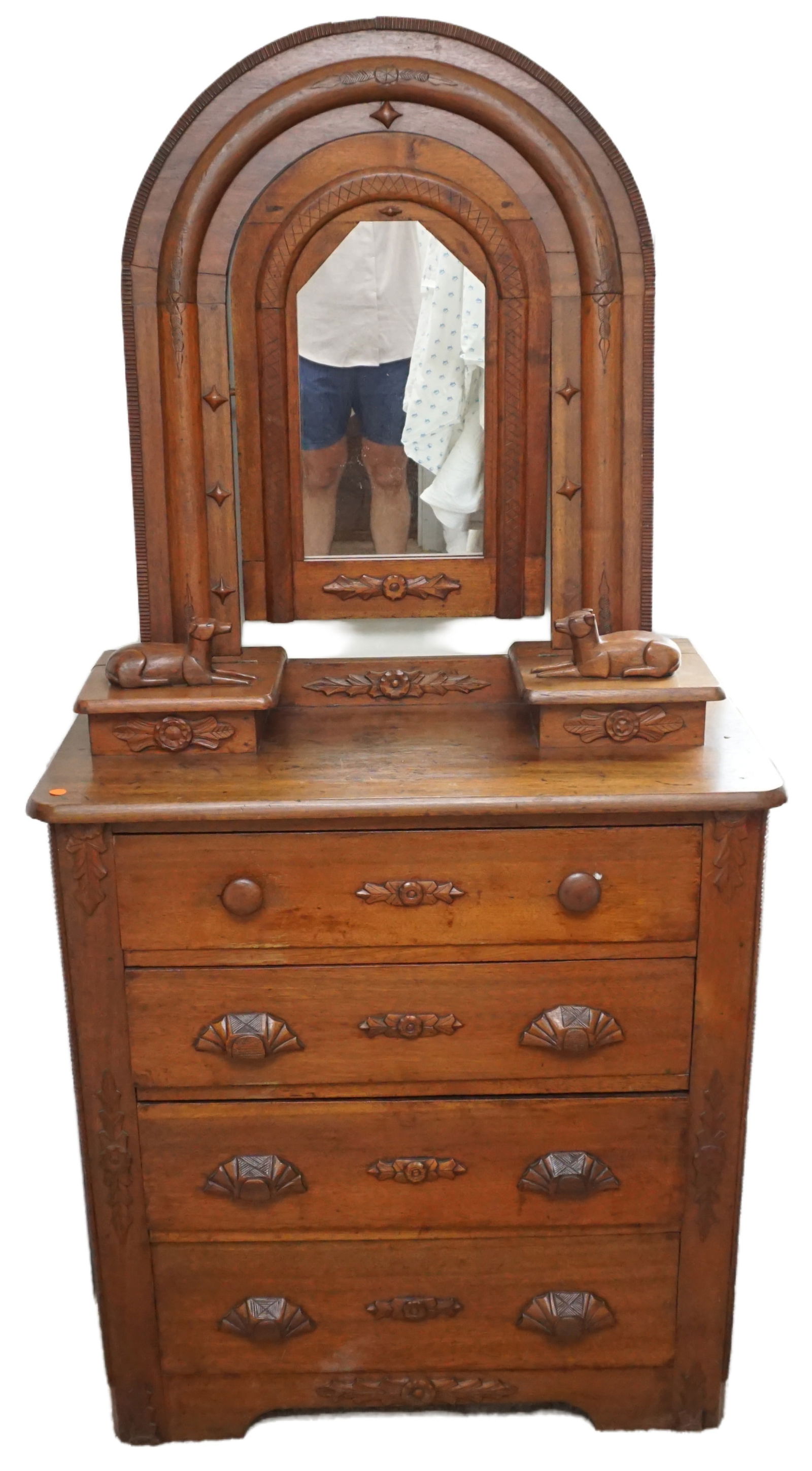 ANTIQUE DRESSER WITH MIRROR: This charming antique dresser is a true statement piece, featuring a unique arched mirror and intricately carved wooden details. The mirror is framed by beautifully curved wood, adding an element of e