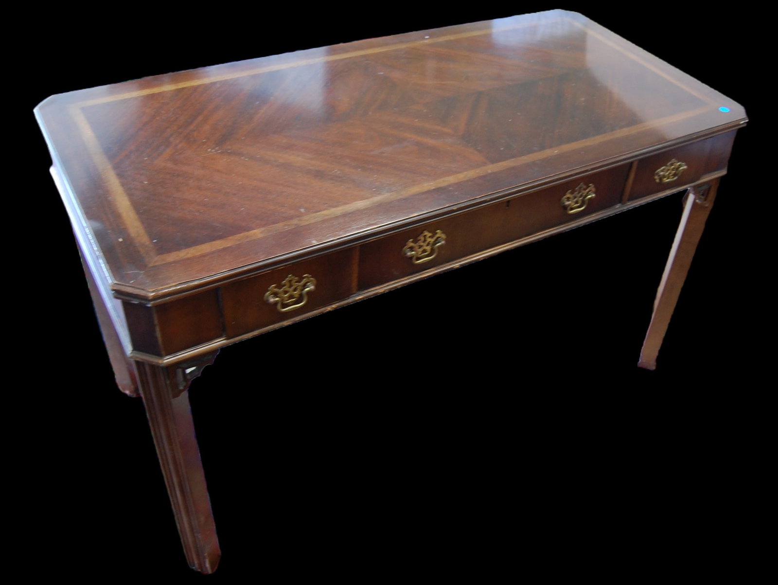 MAHOGANY INLAID THREE-DRAWER DESK: Stunning mahogany desk with intricate inlaid details and three spacious drawers. The wood grain is beautifully preserved, and the brass handles add a touch of sophistication. This desk is ideal for an