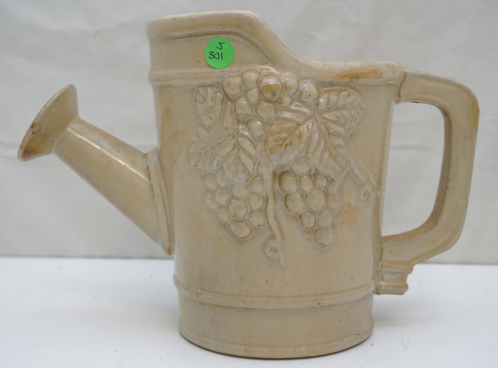 CERAMIC WATERING CAN WITH FLOWER DESIGN: A charming ceramic watering can adorned with a detailed flower design. This piece combines practicality with decorative appeal, perfect for enhancing your garden or interior decor. Measures approximat