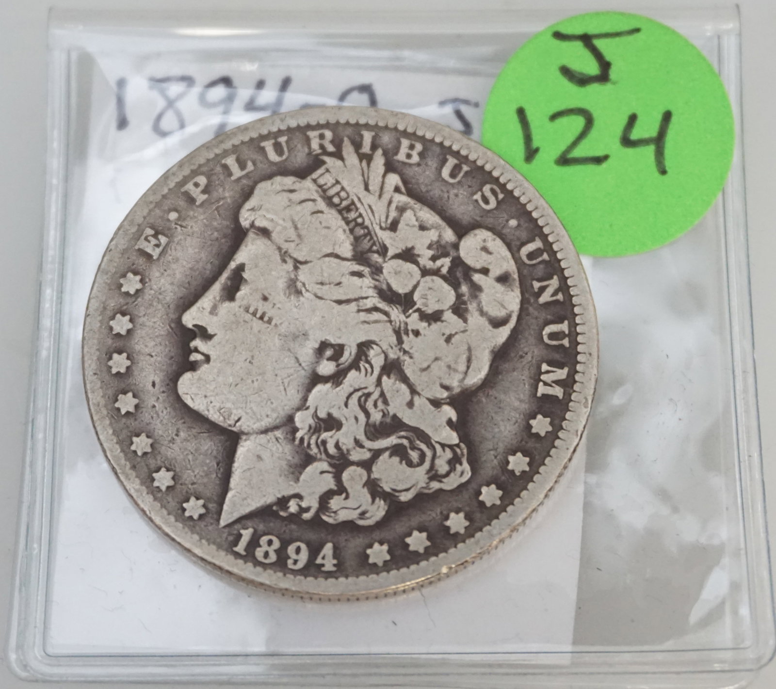 1894-O MORGAN SILVER DOLLAR- Fair - UNGRADED: The 1894-O Morgan Silver Dollar, in Fair condition but ungraded, is a rare find from the New Orleans Mint. This coin exhibits considerable wear but retains its historical significance, featuring Lady 
