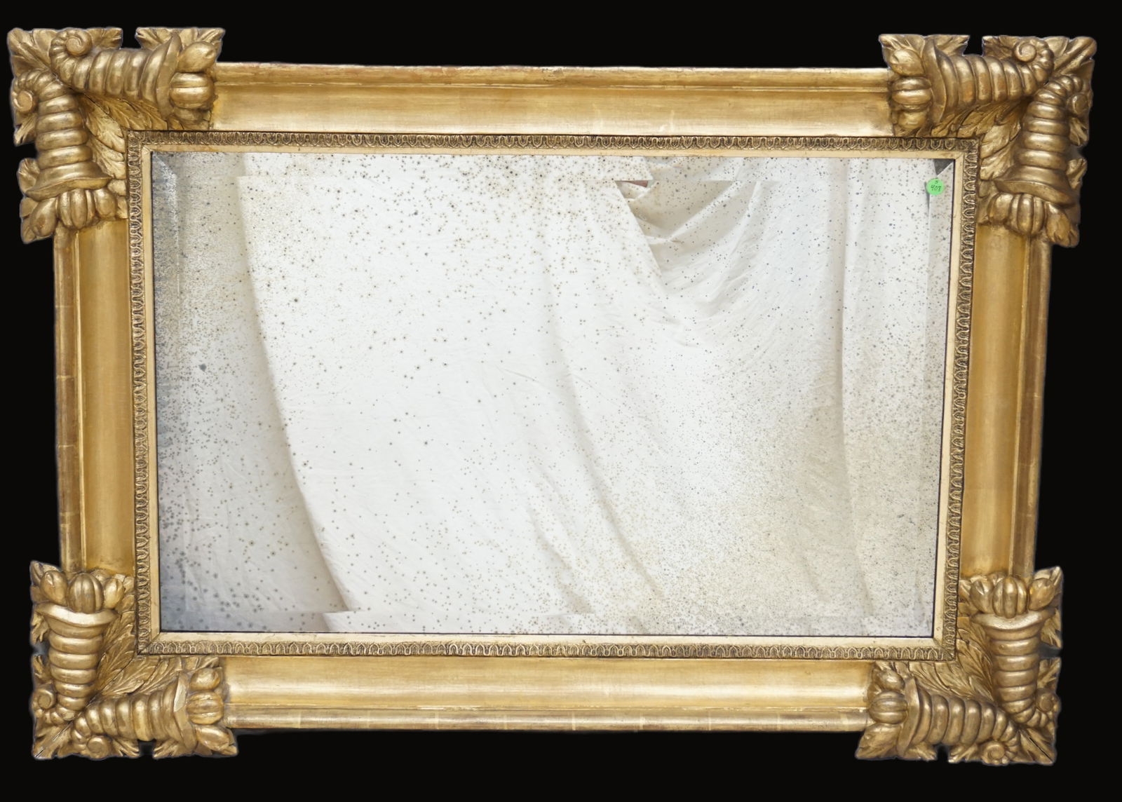 ELABORATE ANTIQUE MIRROR: Old mirror. Mirror measures 36.5 X 22.5. In frame measures 48X 33.5 X 3.5 inches deep. Where to frame. Spotting to mirror.