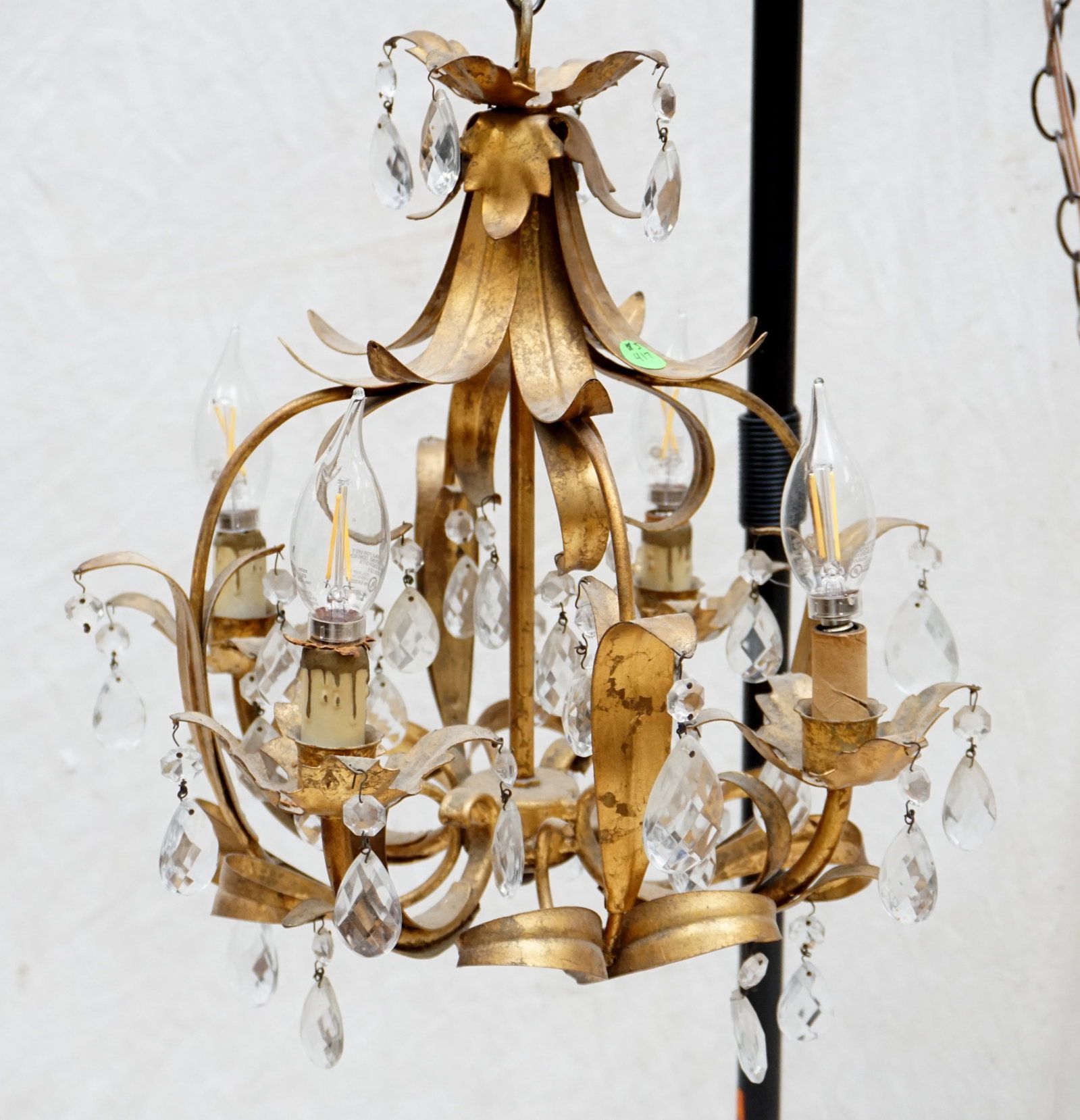 ANTIQUE CRYSTAL AND BRASS CHANDELIER: This exquisite antique chandelier features delicate crystal drops and a brass frame with a beautifully aged patina. The chandelier's ornate design includes intricately carved brass arms and fixtures t