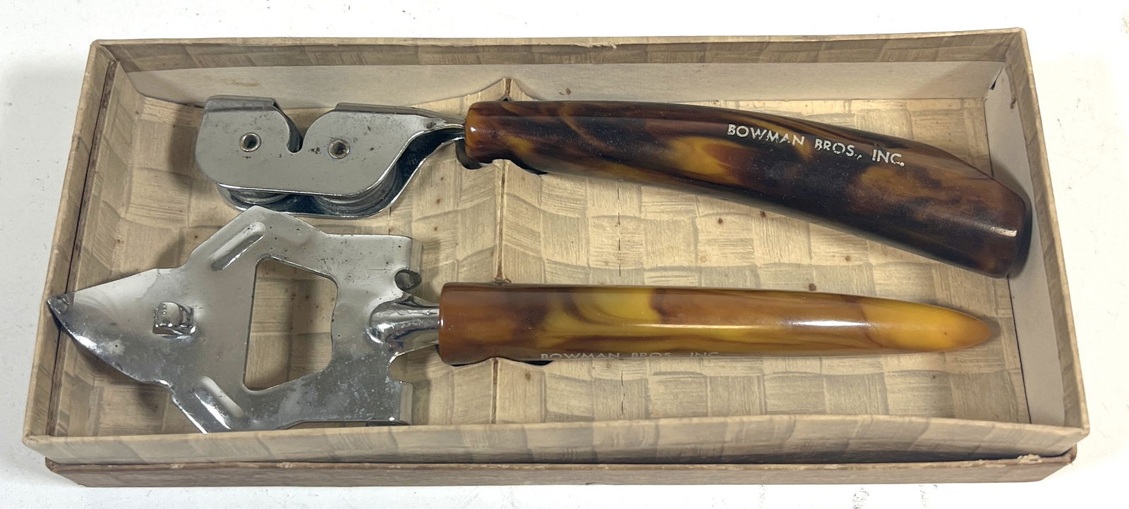 2PC BOWMAN BROS. KITCHEN ACCESSORIES: Pair of vintage kitchen accessories by Bowman Bros., featuring a can opener and a bottle opener. Both tools have chrome metal heads and faux tortoiseshell plastic handles, showing light wear and patin