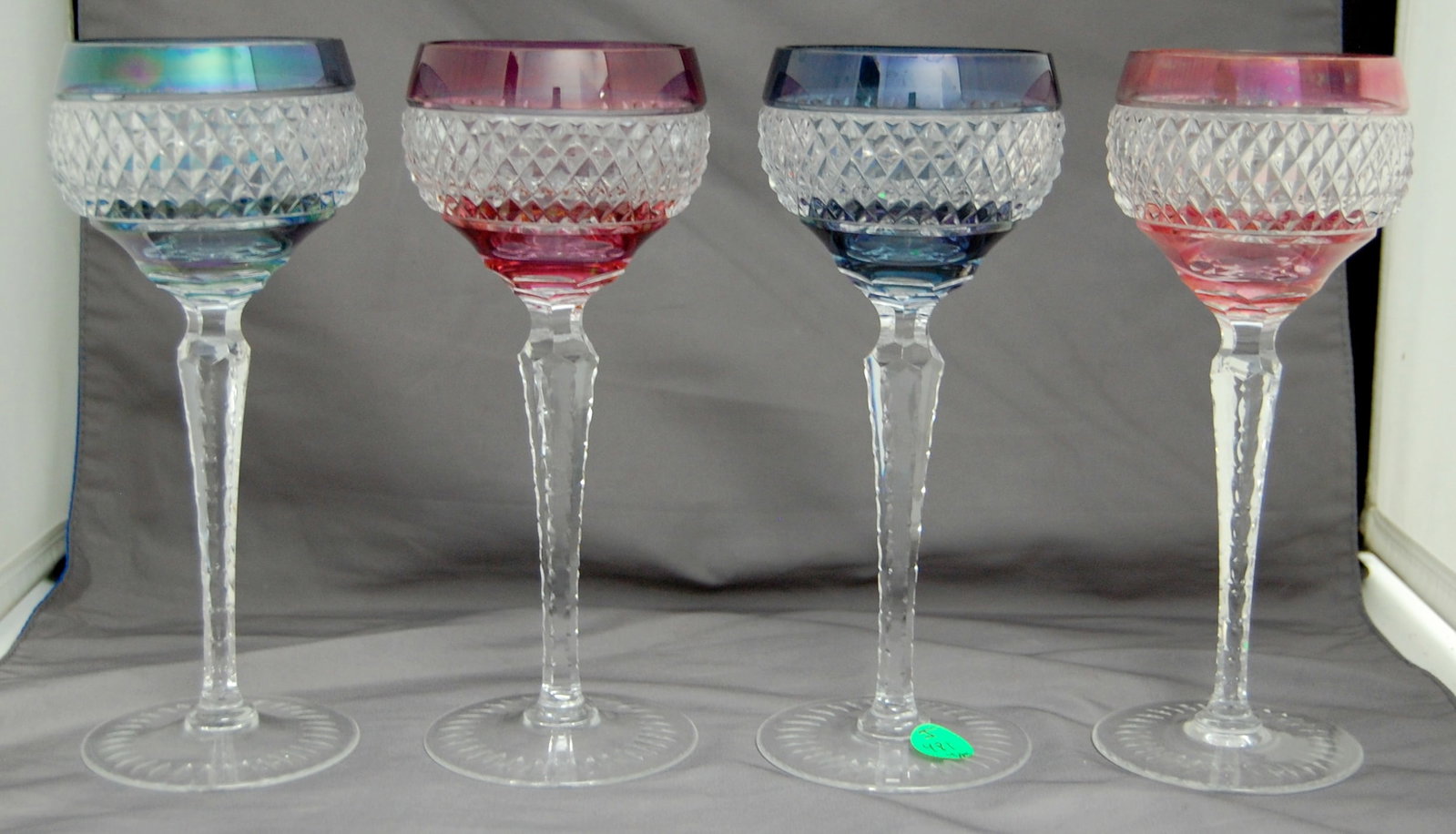 4PC COLORED WINE GLASSES: A set of 4 colored wine glasses, each standing 8.25" high. The unique colors and design make them perfect for formal dining or display.