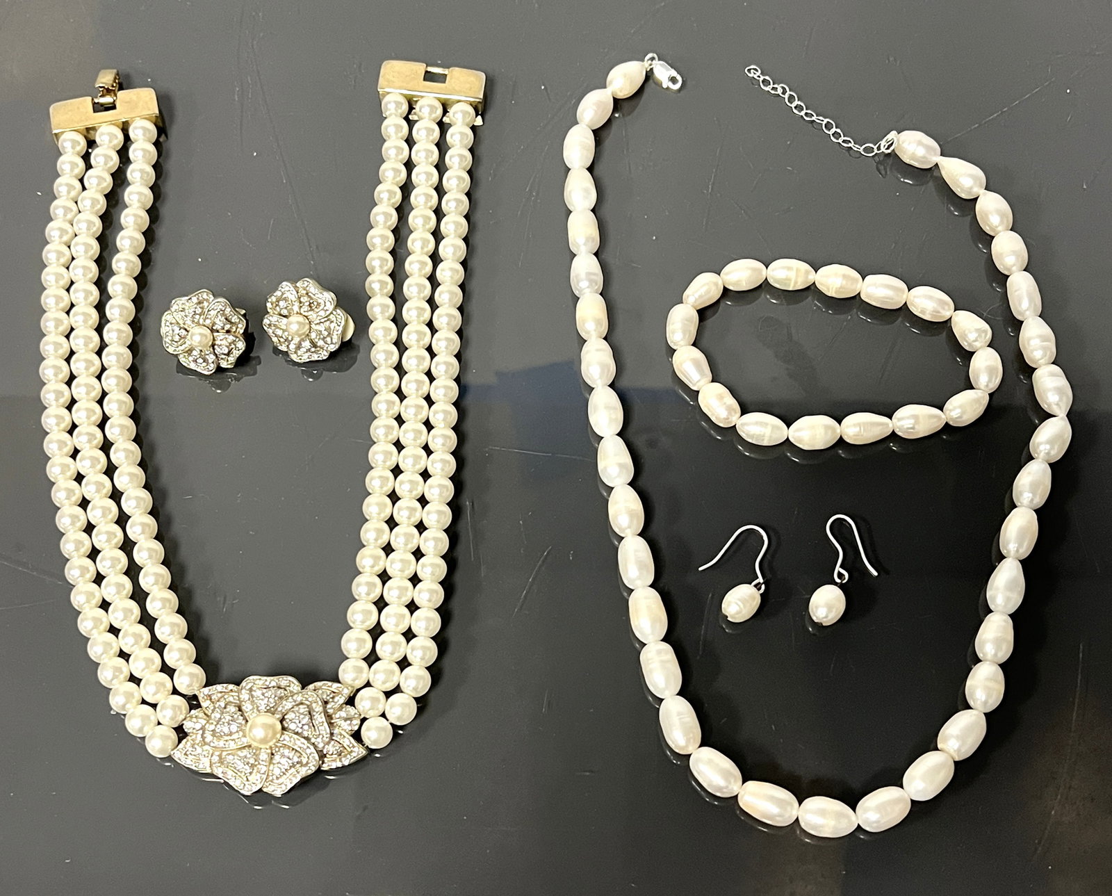 SOPHISTICATED COLLECTION FEATURING TWO ELEGANT PEARL SETS: A sophisticated collection featuring two elegant pearl sets. The first set includes a faux pearl necklace adorned with a dazzling rhinestone floral clasp, measuring 15.5? long, accompanied by matching