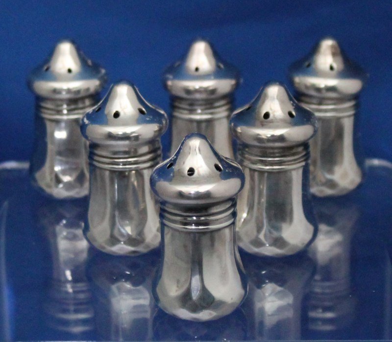 6 INDIVIDUAL STERLING SILVER SALTS: Set of 6 individual Sterling Silver salt and pepper shakers. Approx. 2" tall x 1" wide at the base. Weight 44 grams. Excellent condition, minor tarnish/patina, no dents, bends. Provenance: From the E