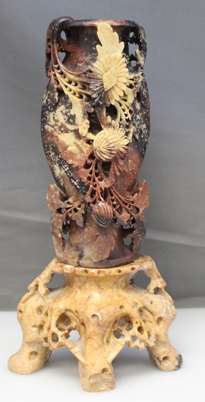 ORNATE CHINESE CARVED SOAPSTONE VASE & STAND: Circa late 19th/early 20th century Chinese elaborately openwork carved soapstone vase; in the form of a flowering plant, on ornate carved soapstone stand. Stand has chip to the front of one foot. 9" t