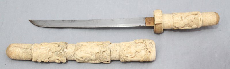 19TH CENTURY JAPANESE MEIJI PERIOD BONE WAKIZASHI: Antique Japanese Meiji period Wakizashi or side sword, having a bone saya and tsuka covered in carved high relief scenes of geishas, 18.25". Beautiful carved work of better quality, age related wear, 
